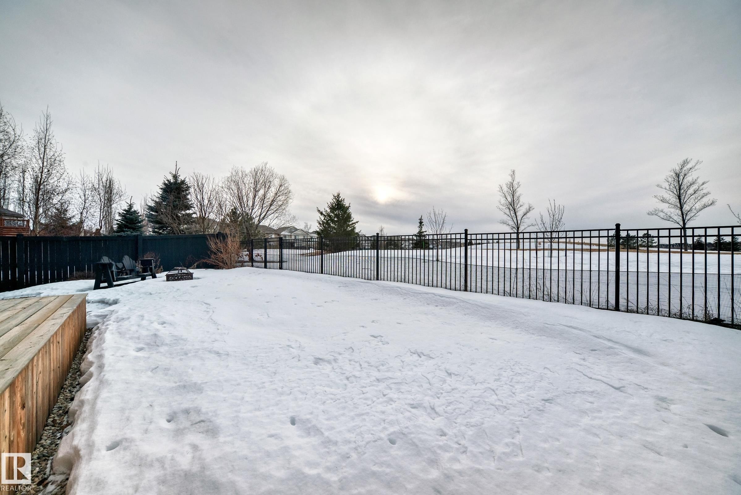 Snowy yard with a fenced backyard and a fire pit - 1908 69 Street, Edmonton, AB - Outdoor