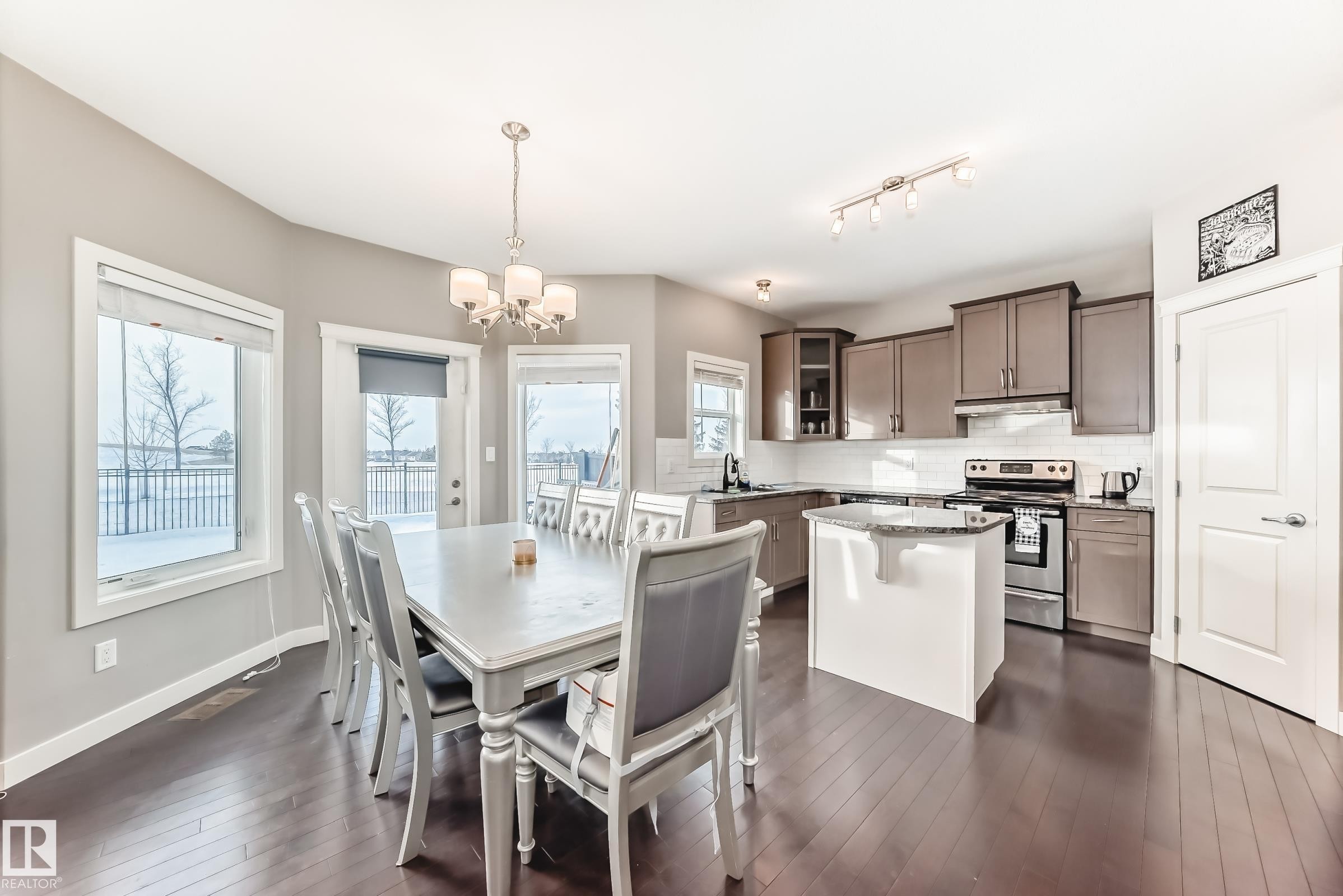 Dining area featuring suspended lighting and dark wood-style floors - 1908 69 Street, Edmonton, AB - Indoor