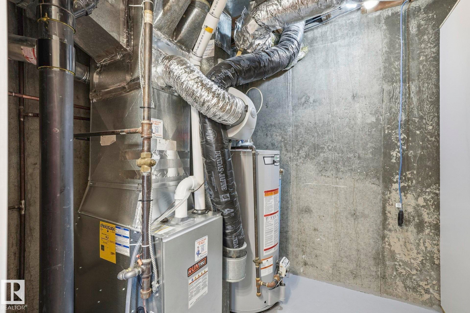 Utilities with water heater and heating unit - Edmonton, AB - Indoor Photo Showing Basement