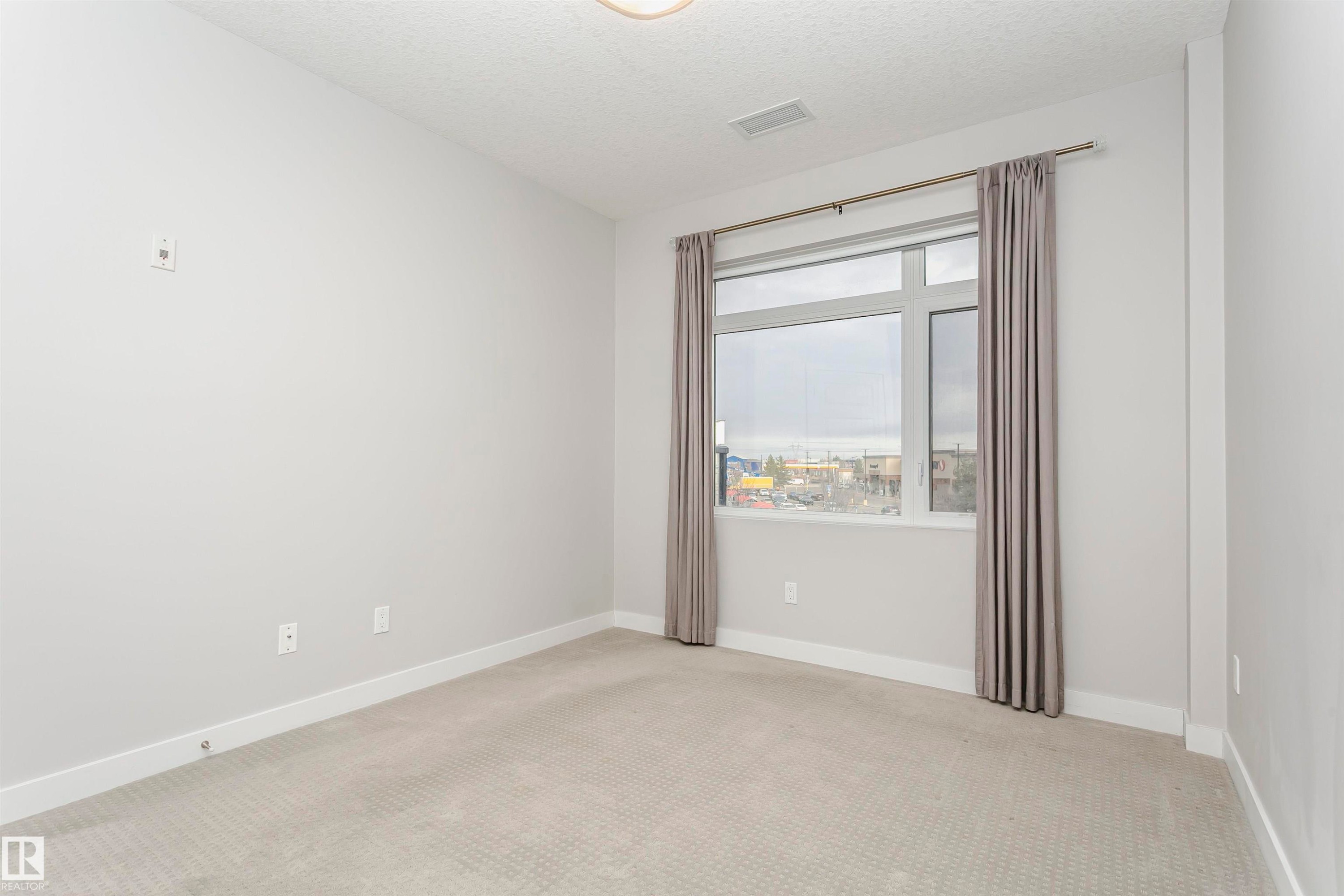 Empty room with carpet and a textured ceiling - 332 5151 Windermere Boulevard, Edmonton, AB - Indoor Photo Showing Other Room