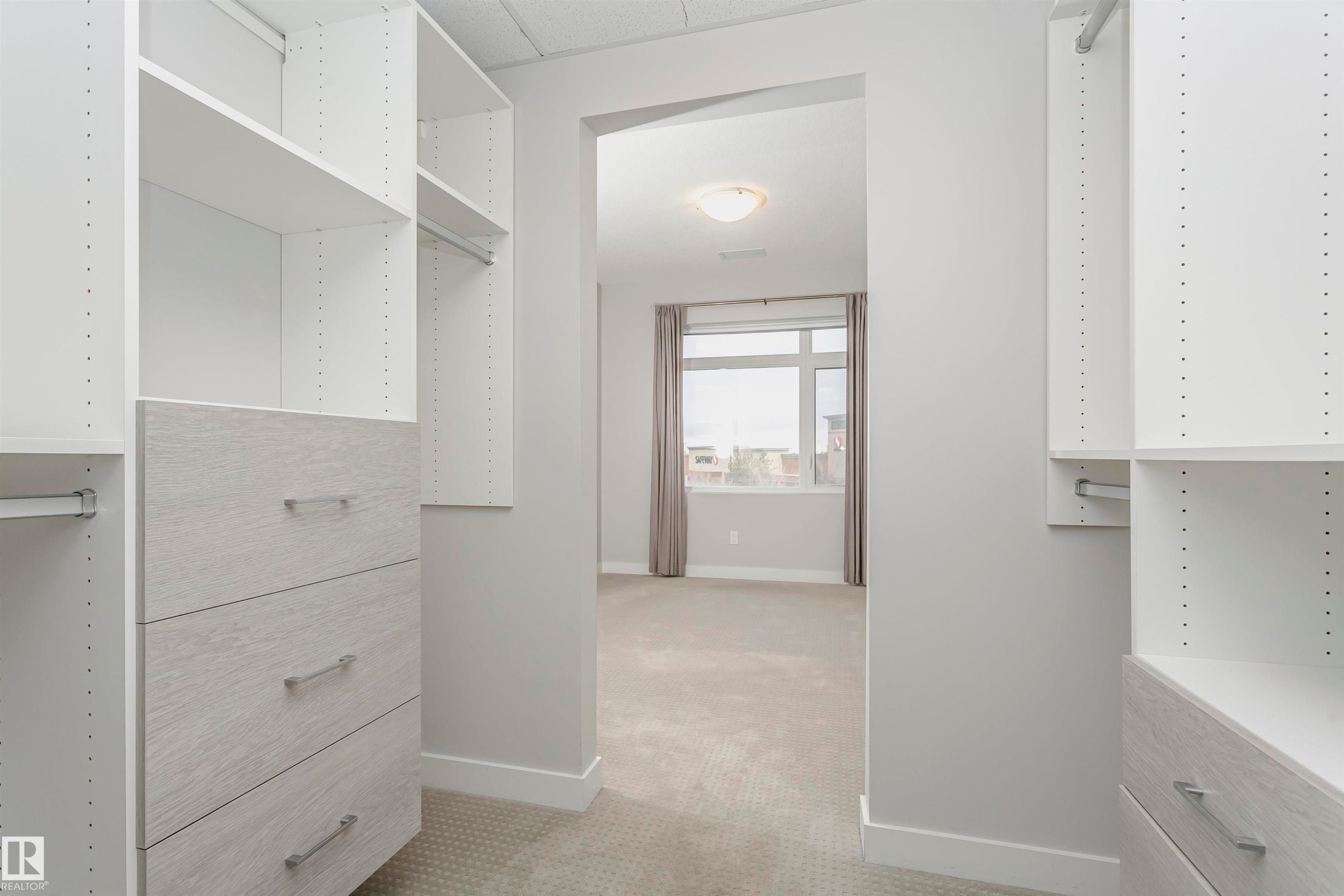 Walk in closet featuring light colored carpet - 332 5151 Windermere Boulevard, Edmonton, AB - Indoor