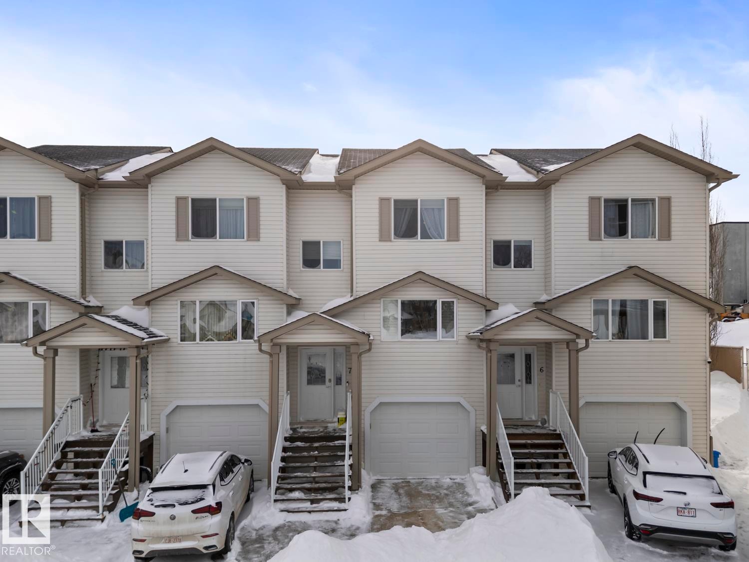 View of front of home featuring an attached garage - 7 1001 7 Avenue, Cold Lake, AB - Outdoor With Facade