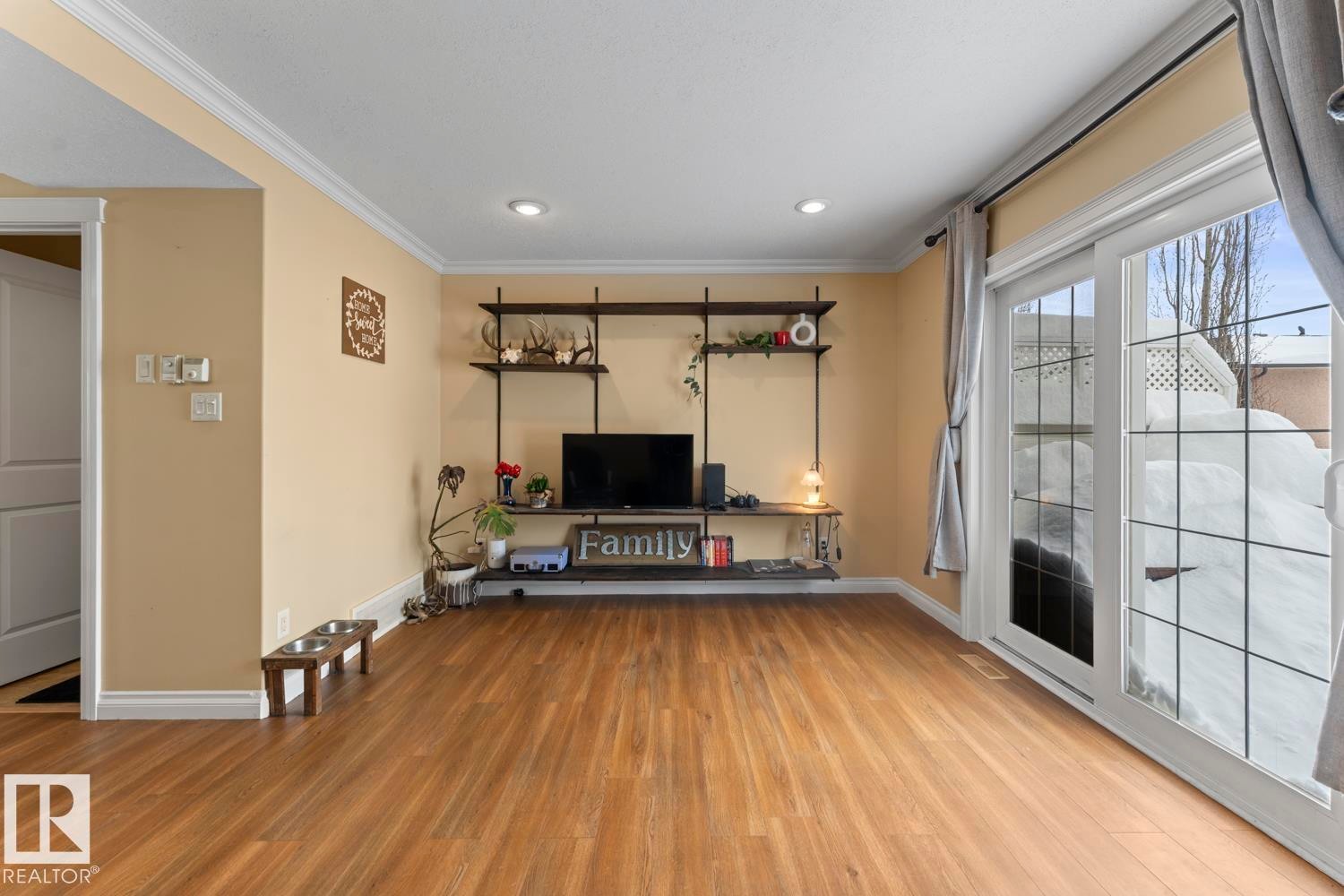 Living area with light wood finished floors, crown molding, and recessed lighting - 7 1001 7 Avenue, Cold Lake, AB - Indoor