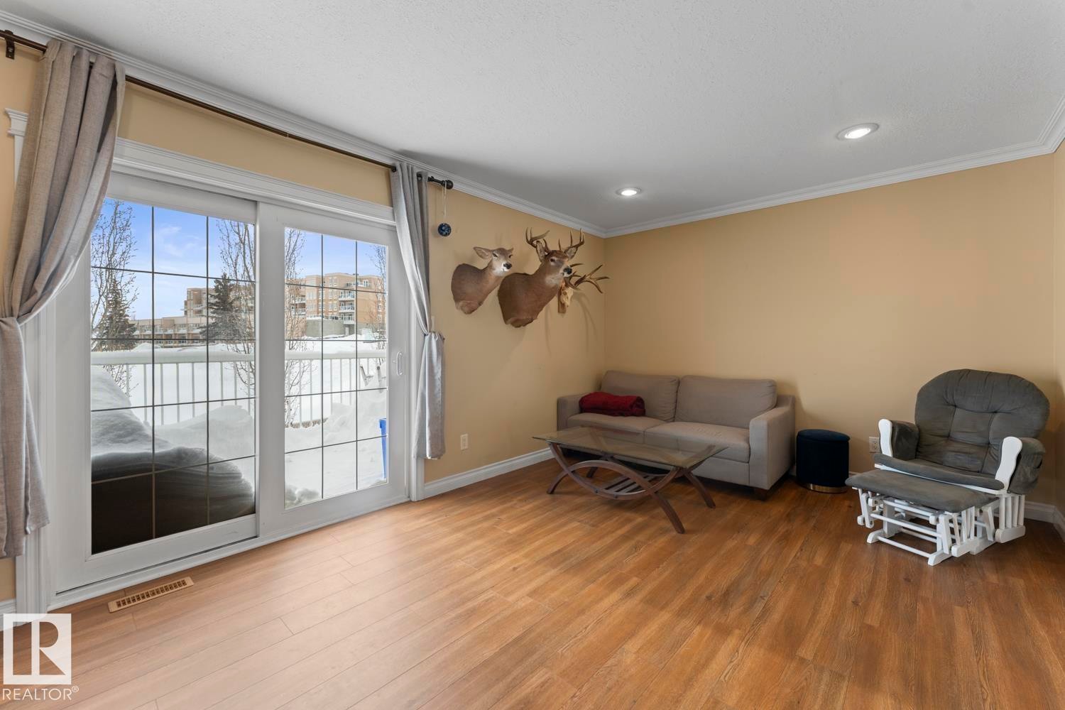 Sitting room featuring wood finished floors, ornamental molding, and recessed lighting - 7 1001 7 Avenue, Cold Lake, AB - Indoor