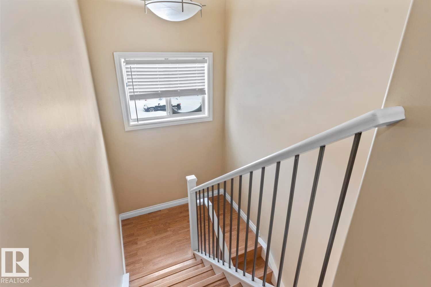 Staircase featuring wood finished floors - 7 1001 7 Avenue, Cold Lake, AB - Indoor Photo Showing Other Room