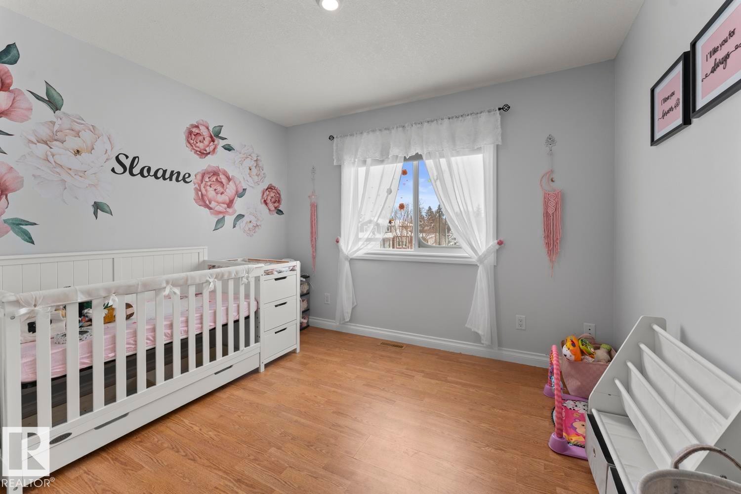 Bedroom with a crib and light wood finished floors - 7 1001 7 Avenue, Cold Lake, AB - Indoor Photo Showing Bedroom