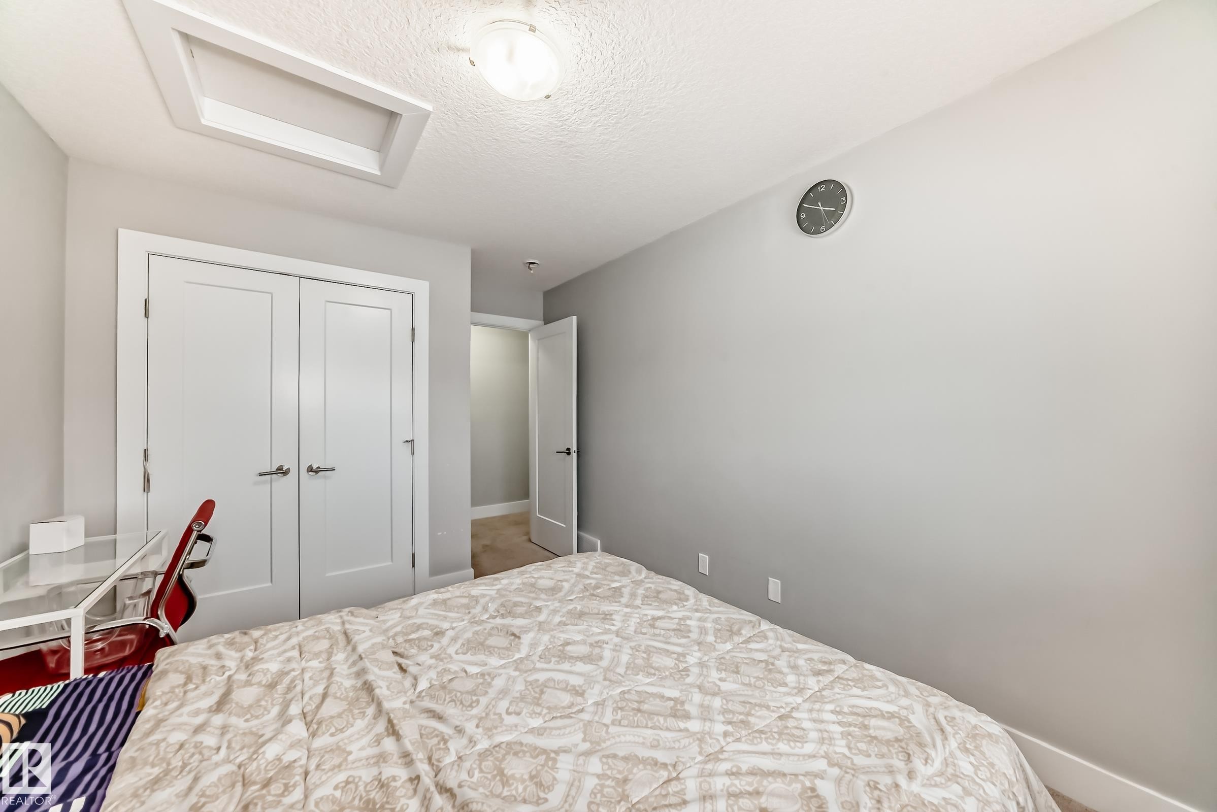 Bedroom with attic access, a textured ceiling, and a closet - 41 4835 Wright Drive, Edmonton, AB - Indoor Photo Showing Bedroom