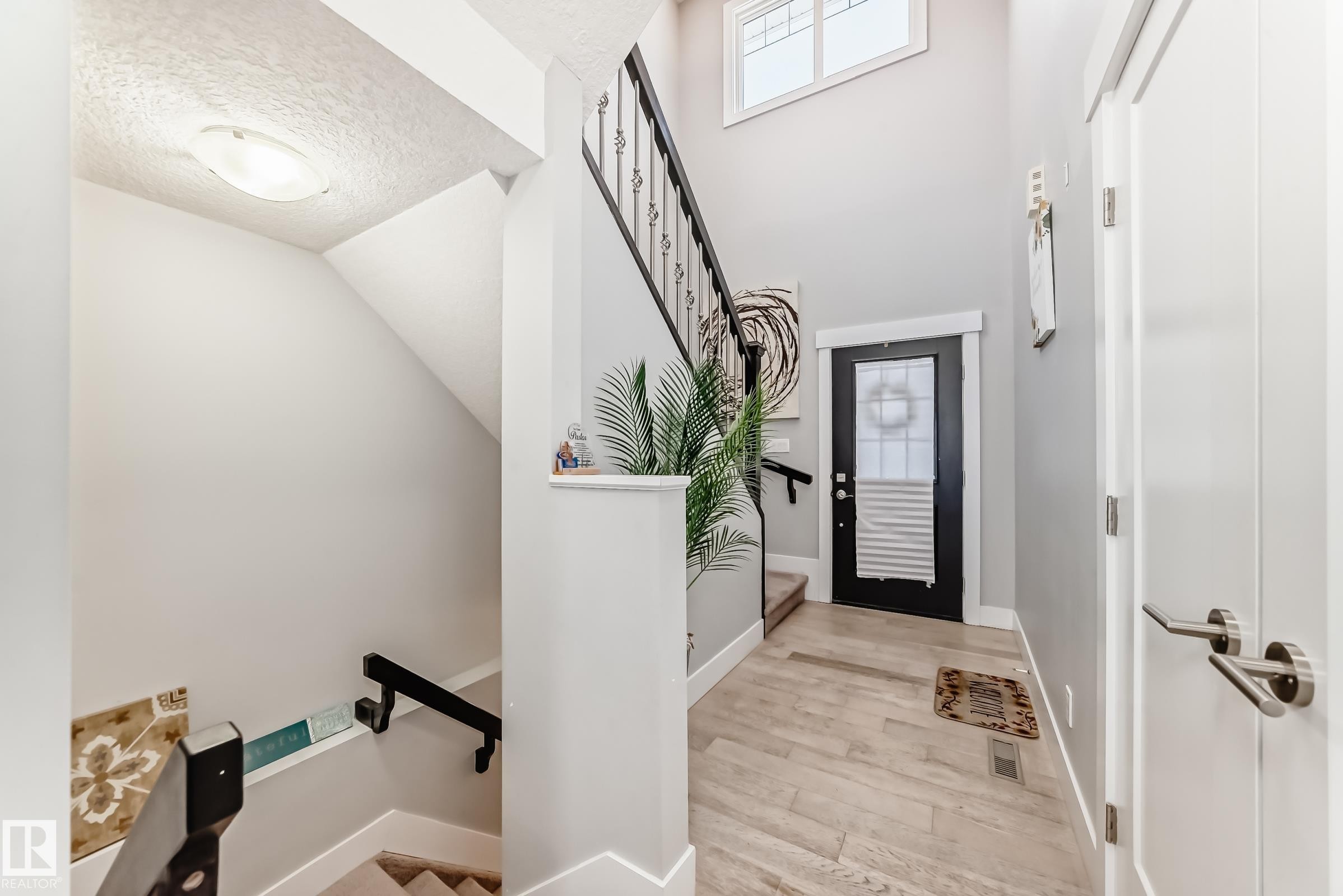 Entryway featuring stairs, light wood-type flooring, and a textured ceiling - 41 4835 Wright Drive, Edmonton, AB - Indoor Photo Showing Other Room