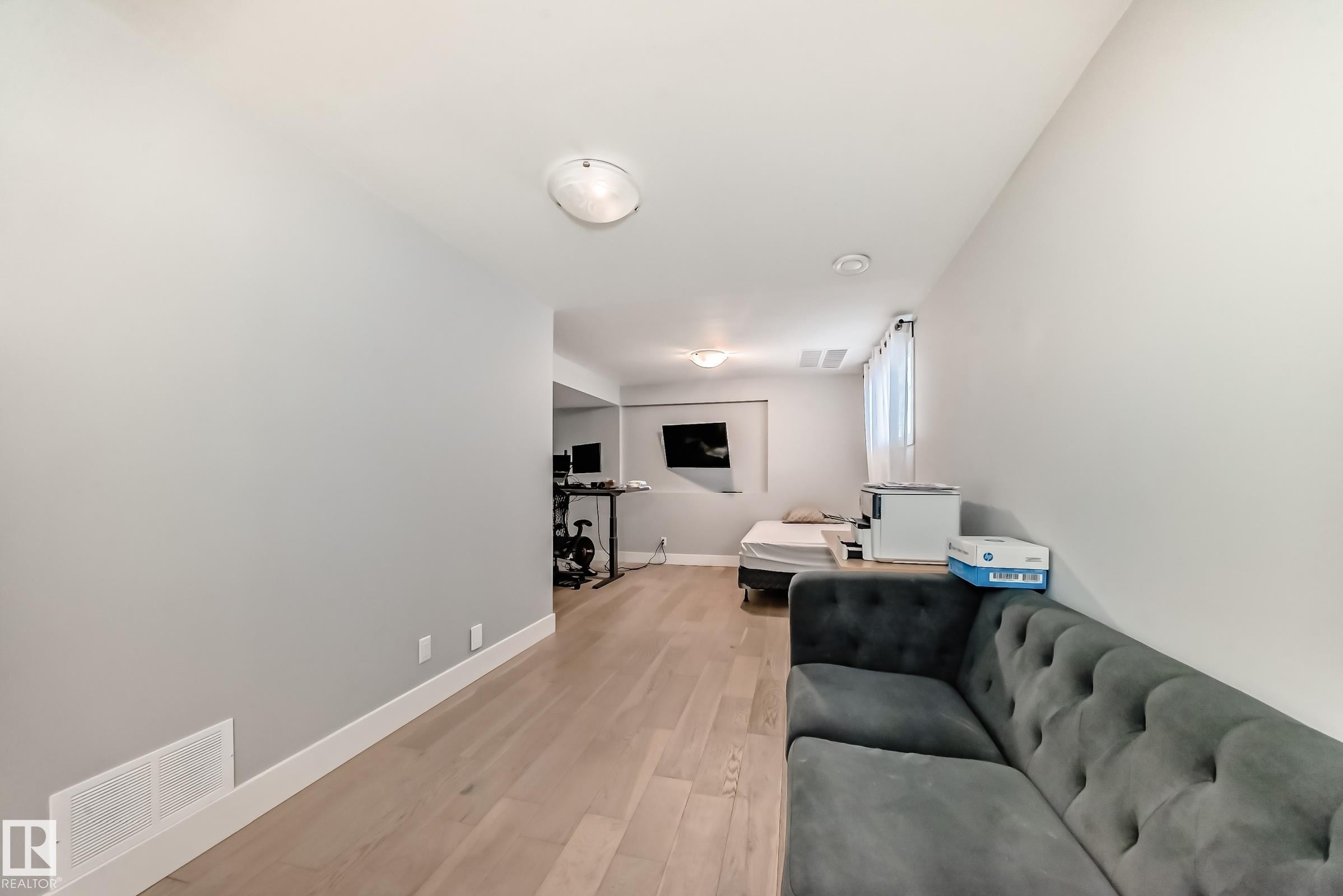 Living room featuring light wood-style floors and an office area - 41 4835 Wright Drive, Edmonton, AB - Indoor