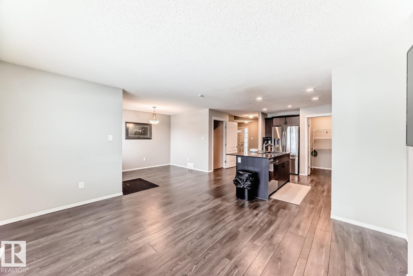 Living room with dark wood finished floors and recessed lighting - 2823 Duke Crescent, Edmonton, AB - Indoor