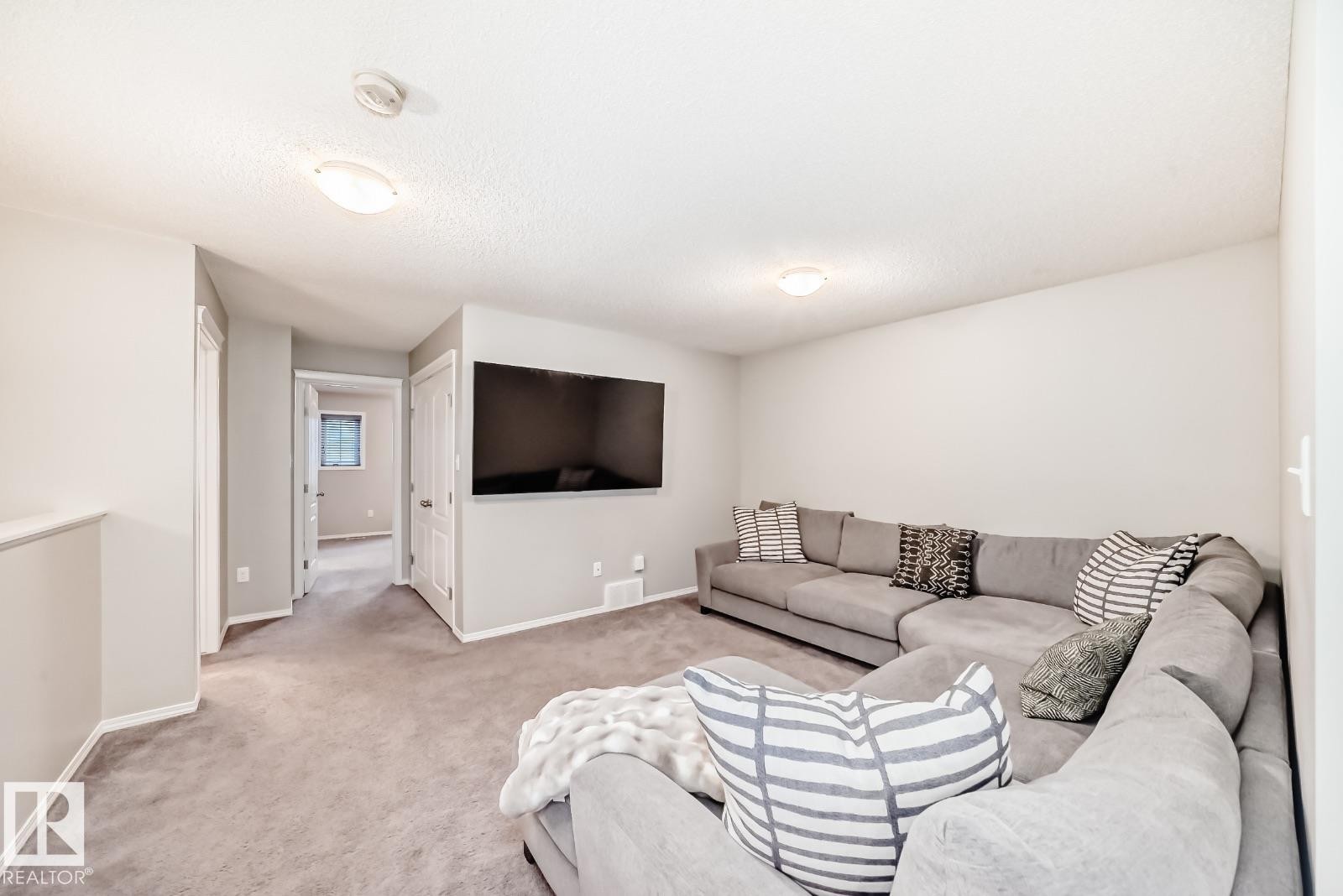 Carpeted living area with baseboards - 2823 Duke Crescent, Edmonton, AB - Indoor Photo Showing Living Room