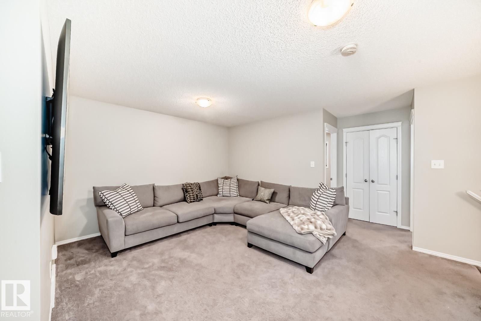 Living area featuring carpet floors and a textured ceiling - 2823 Duke Crescent, Edmonton, AB - Indoor Photo Showing Living Room