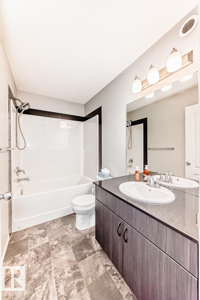 Bathroom featuring vanity and shower / tub combination - 2823 Duke Crescent, Edmonton, AB - Indoor Photo Showing Bathroom