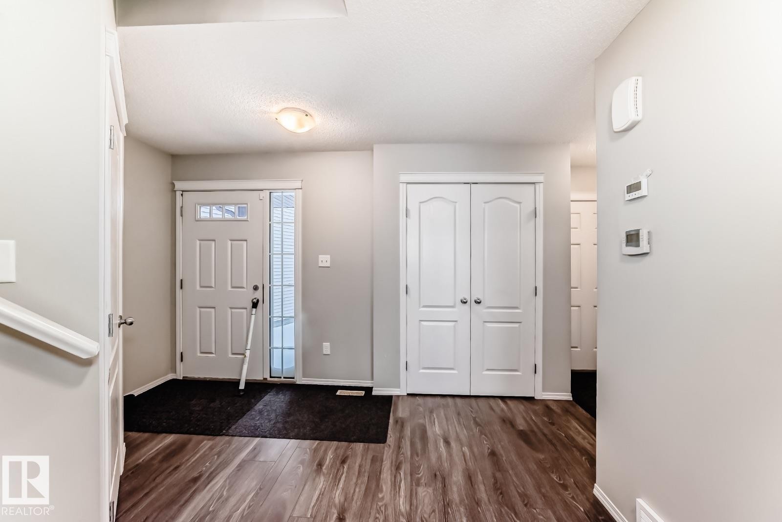 Foyer entrance with dark wood-style floors and baseboards - 2823 Duke Crescent, Edmonton, AB - Indoor Photo Showing Other Room