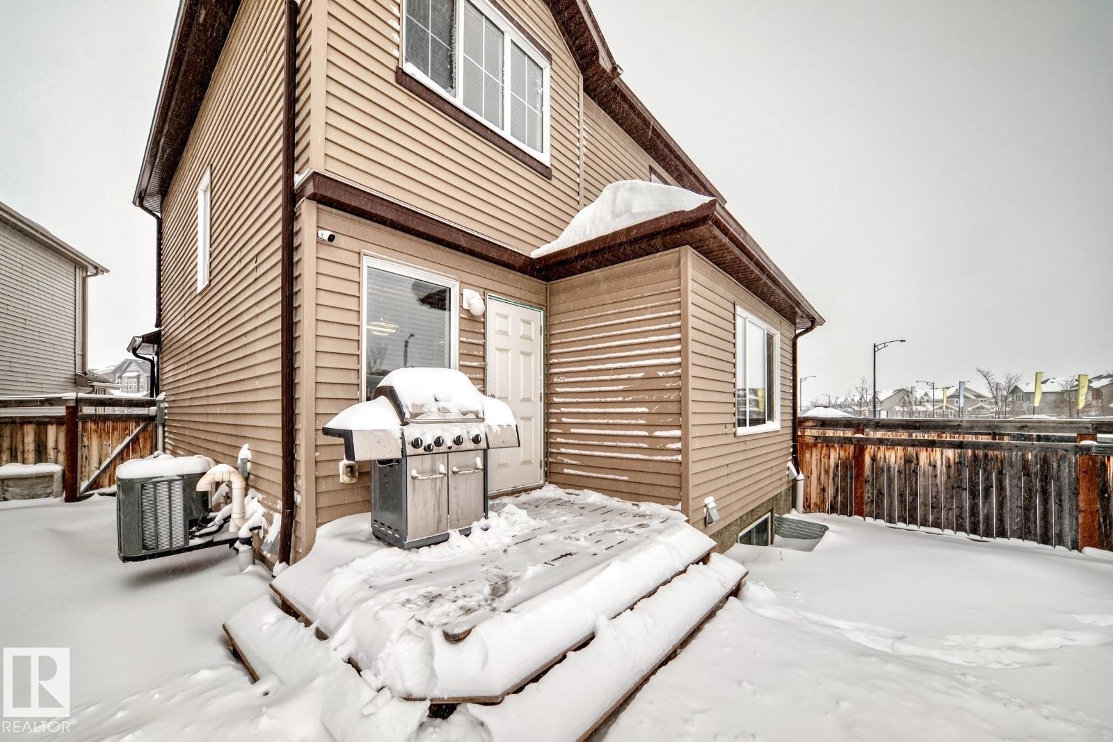Snow covered back of property featuring a deck - 2823 Duke Crescent, Edmonton, AB - Outdoor With Exterior