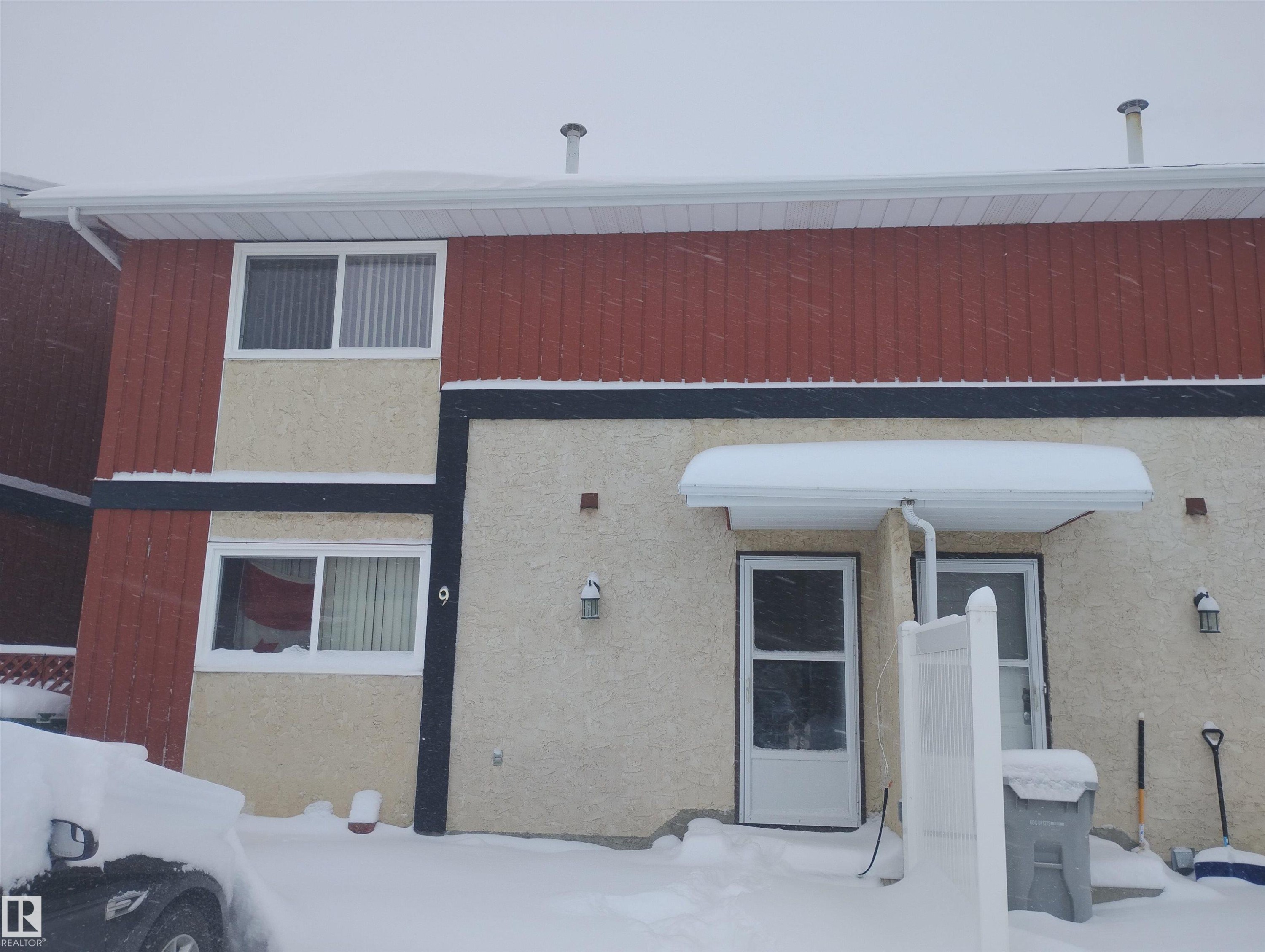 Snow covered house with stucco siding - 9 5325 48 Avenue, Redwater, AB - Outdoor With Exterior