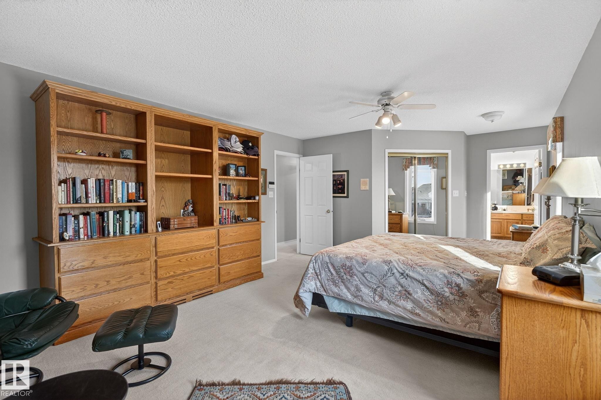 Bedroom featuring light carpet, ensuite bath, a ceiling fan, and a textured ceiling - 313 Hedley Way, Edmonton, AB - Indoor Photo Showing Bedroom