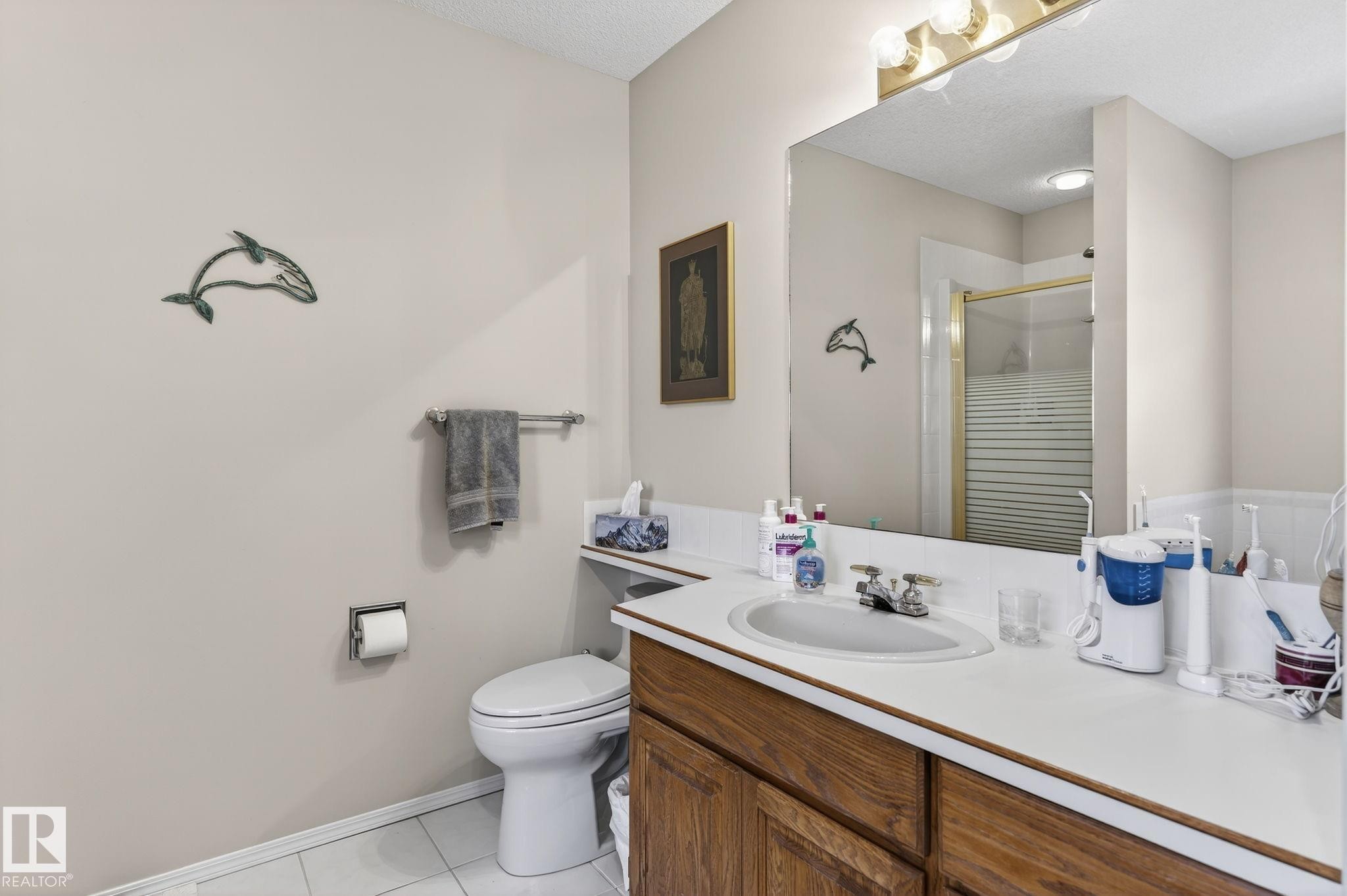 Full bathroom with a shower stall, vanity, and light tile patterned flooring - 313 Hedley Way, Edmonton, AB - Indoor Photo Showing Bathroom