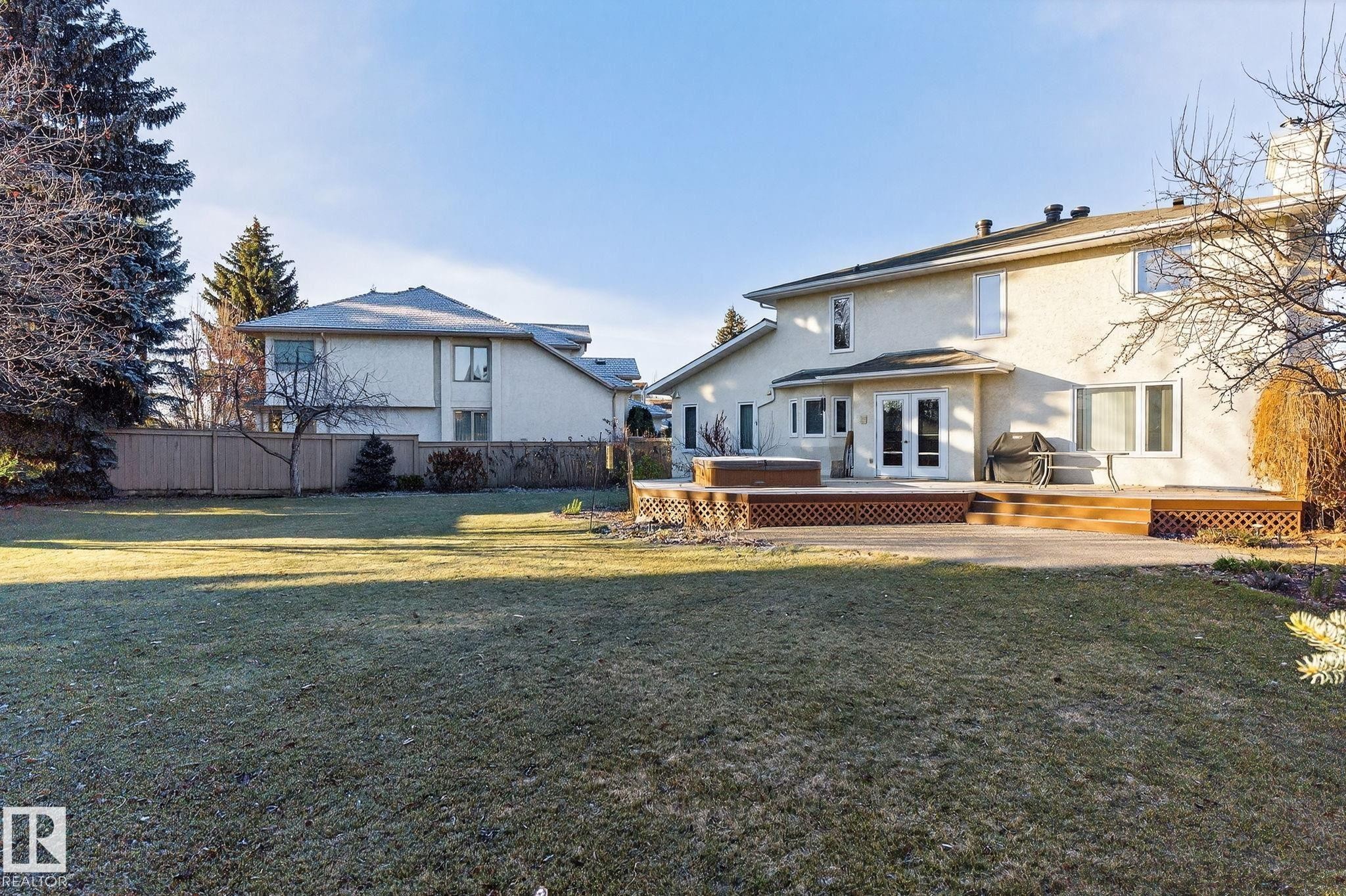 Back of house featuring stucco siding, a wooden deck, and french doors - 313 Hedley Way, Edmonton, AB - Outdoor With Deck Patio Veranda