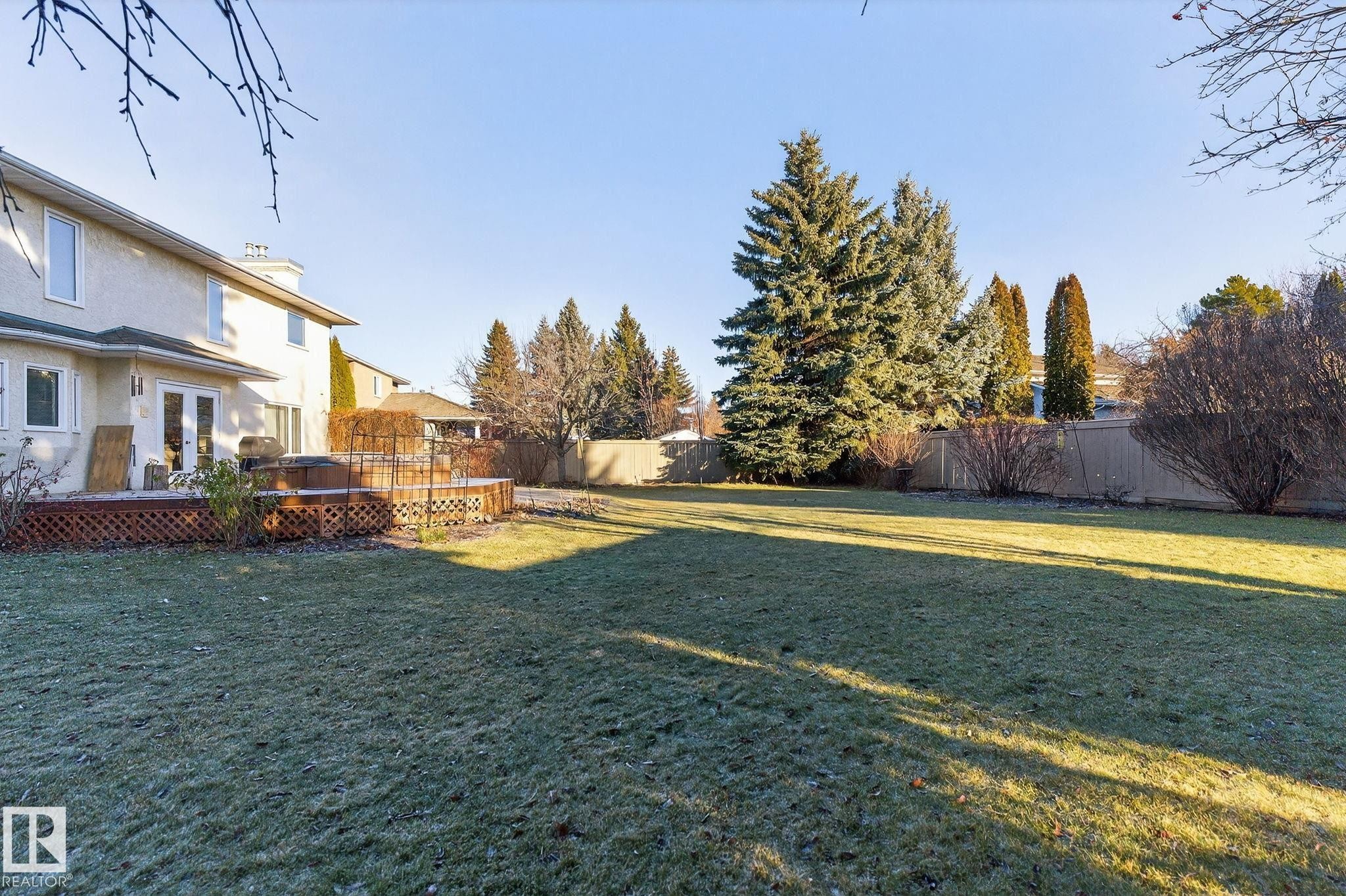 Fenced backyard featuring a wooden deck and french doors - 313 Hedley Way, Edmonton, AB - Outdoor