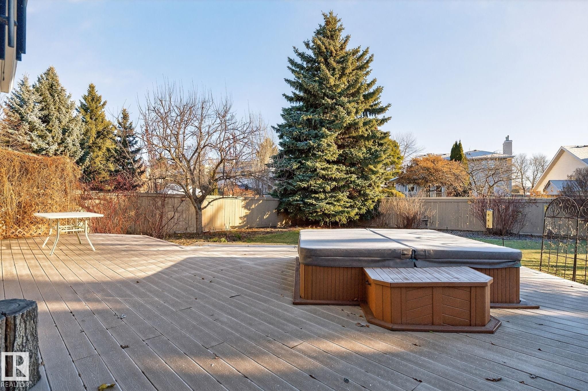 Wooden deck with a fenced backyard and a hot tub - 313 Hedley Way, Edmonton, AB - Outdoor With Deck Patio Veranda