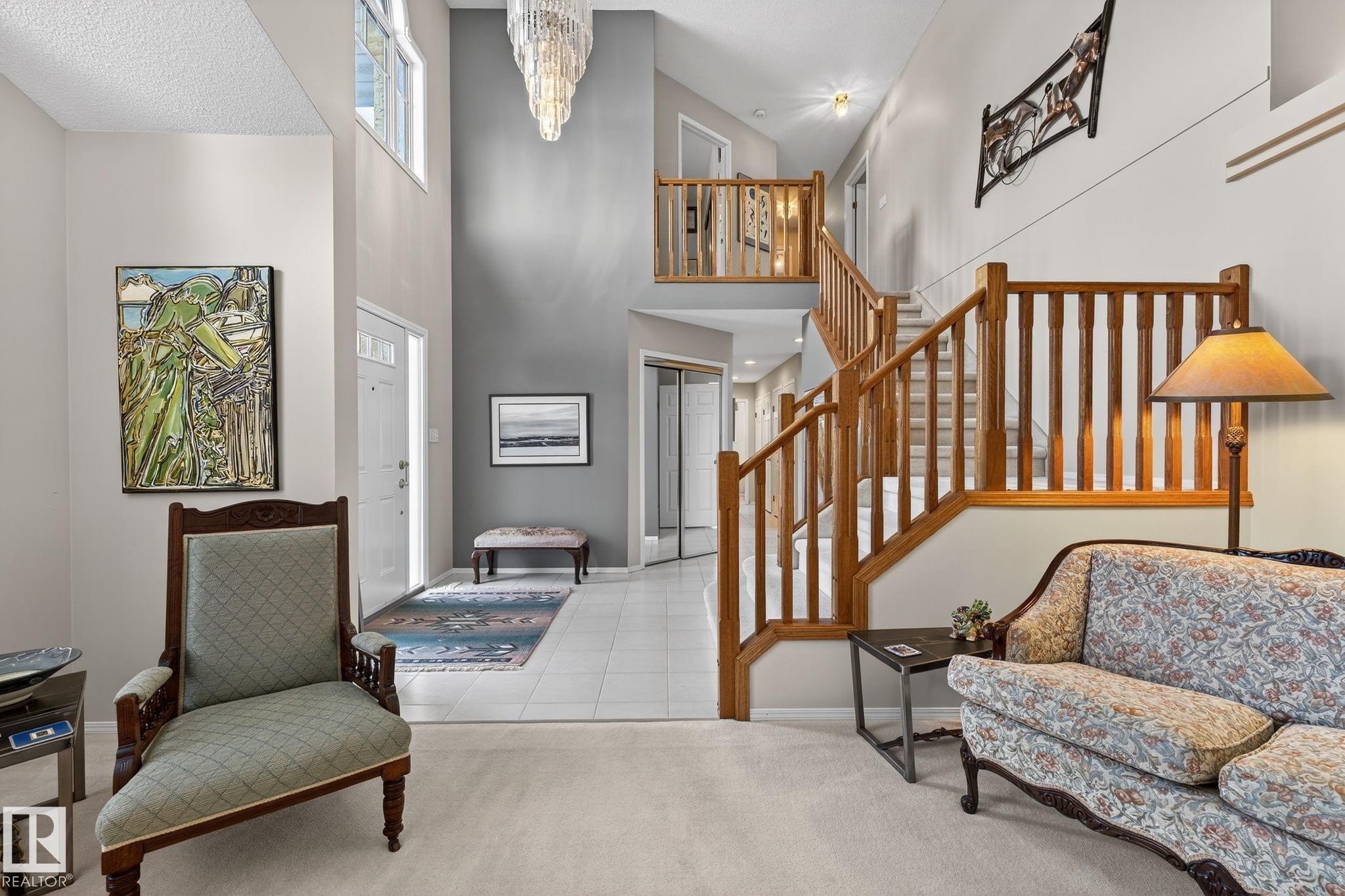Carpeted entryway with hanging lights, tile patterned flooring, and a high ceiling - 313 Hedley Way, Edmonton, AB - Indoor Photo Showing Other Room