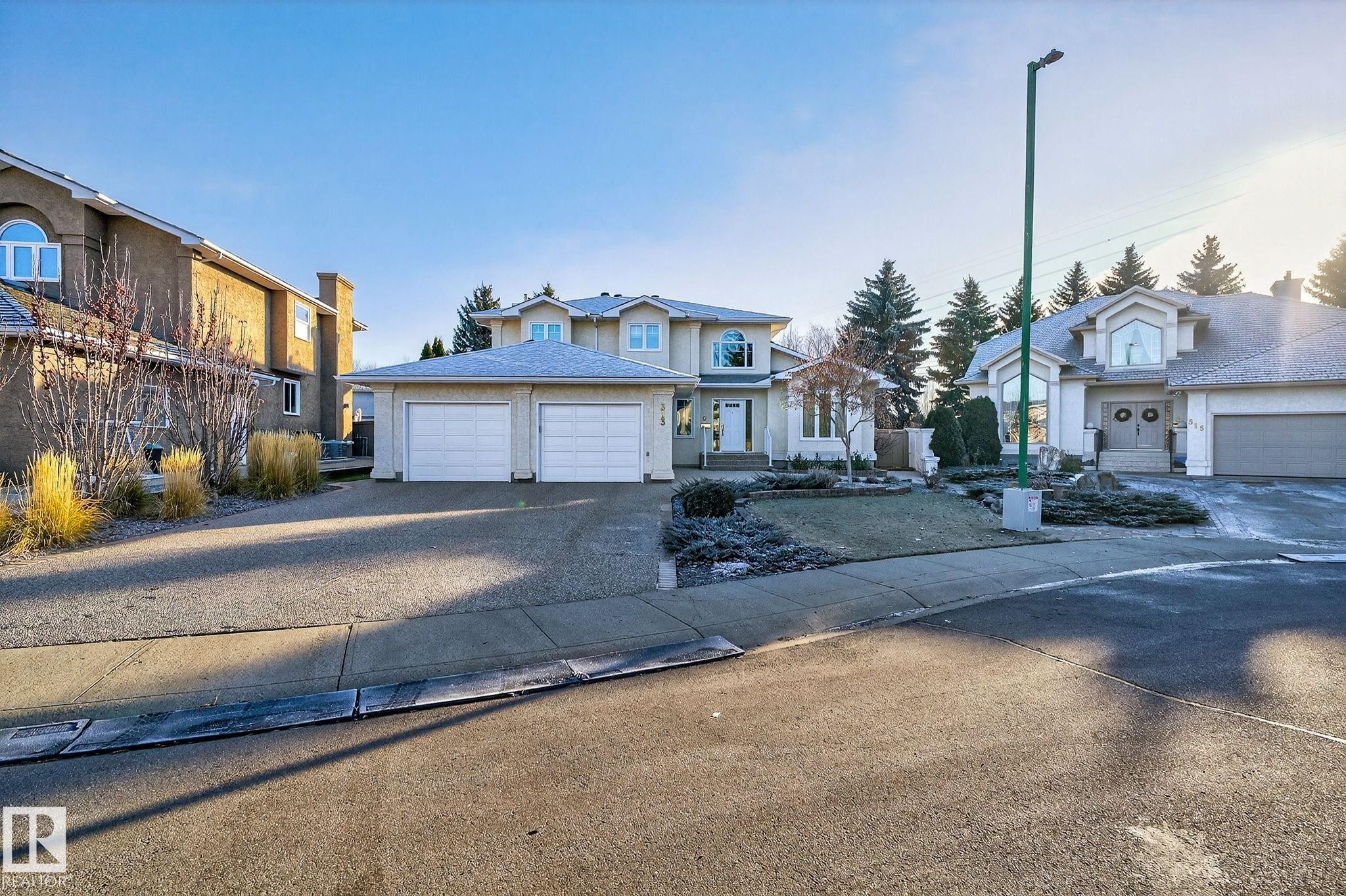 Traditional-style home featuring driveway, a garage, and a residential view - 313 Hedley Way, Edmonton, AB - Outdoor With Facade