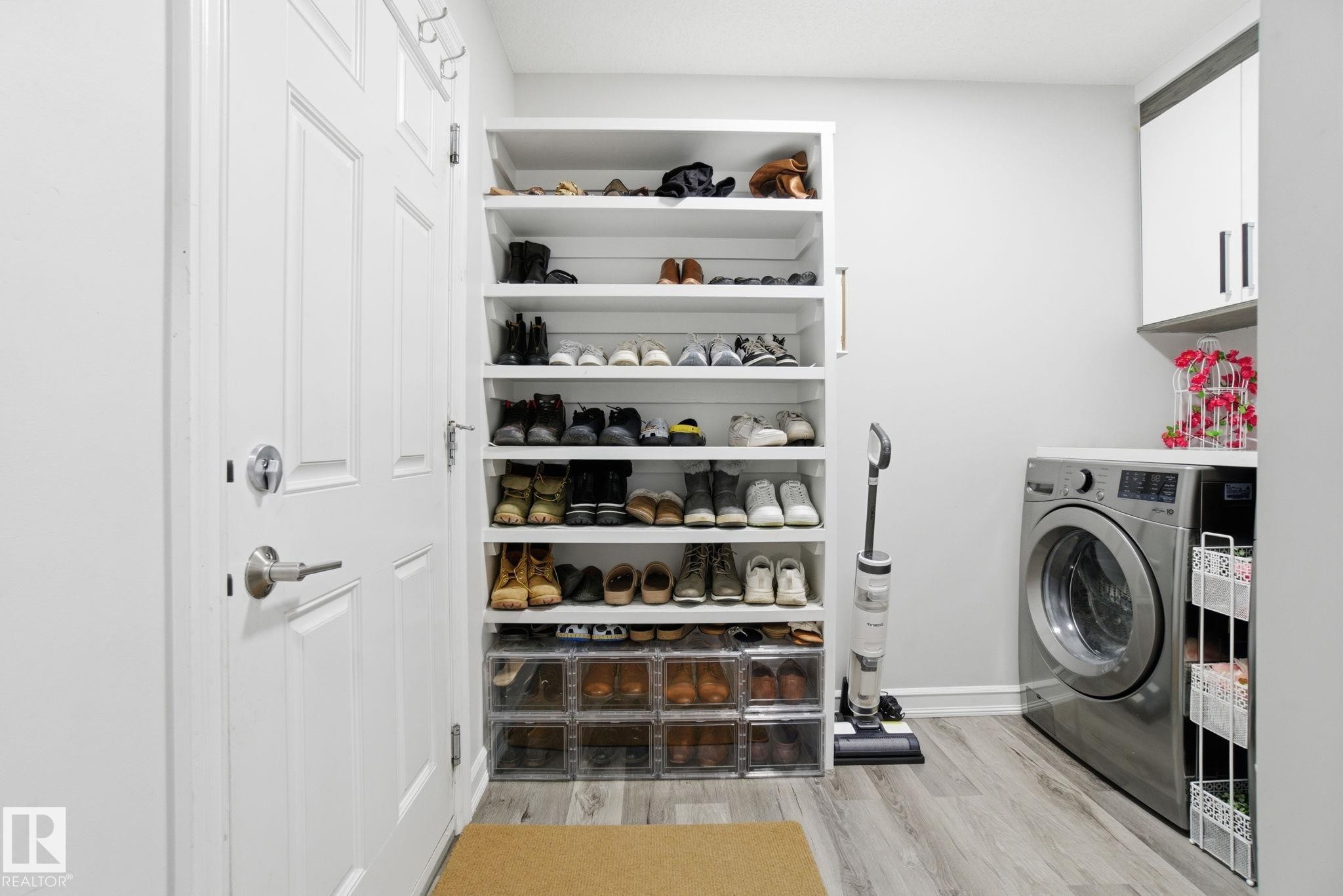 Laundry room with light wood-type flooring, cabinet space, and washer / dryer - 1532 37C Avenue, Edmonton, AB - Indoor Photo Showing Laundry Room