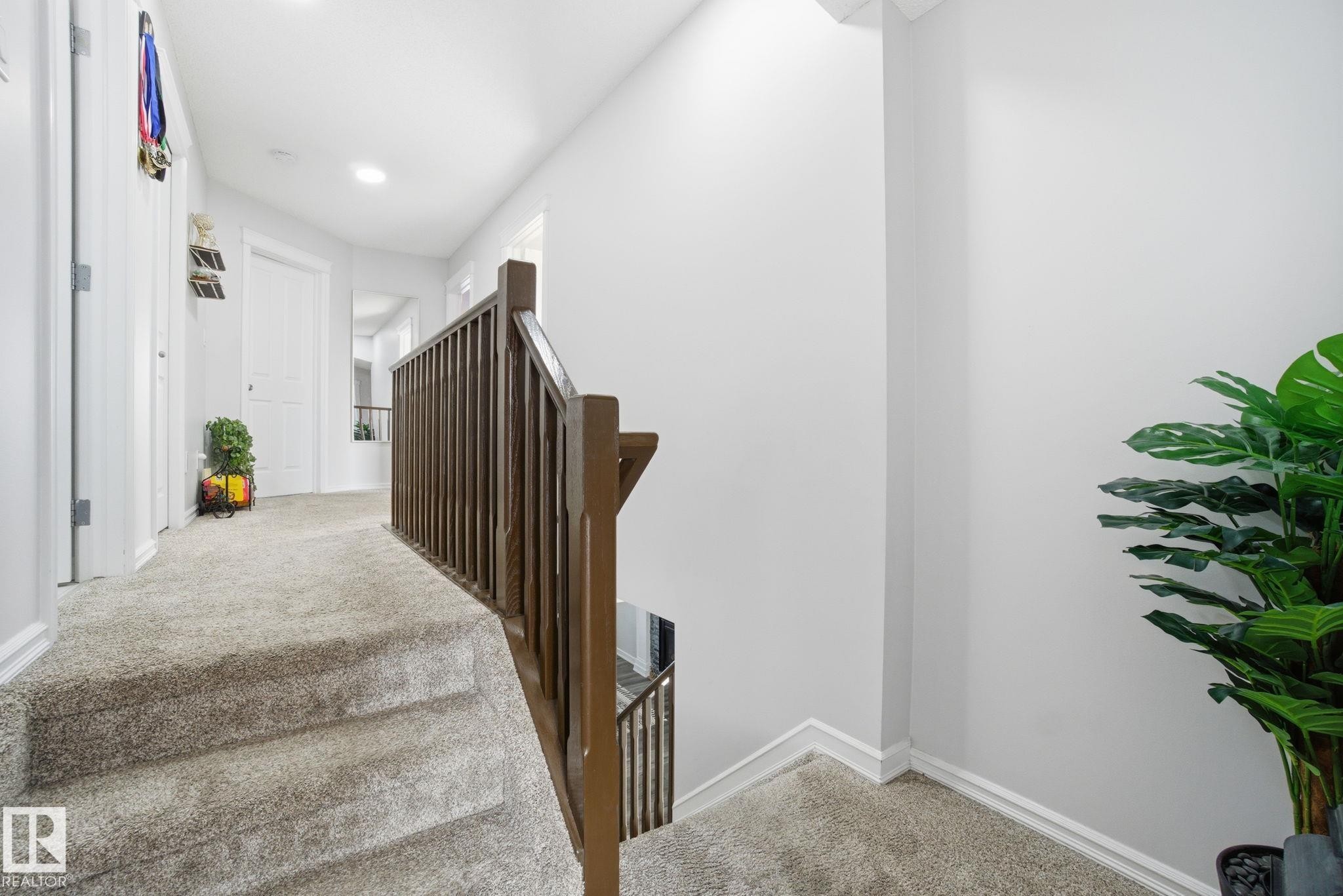 Staircase with carpet flooring and baseboards - 1532 37C Avenue, Edmonton, AB - Indoor Photo Showing Other Room