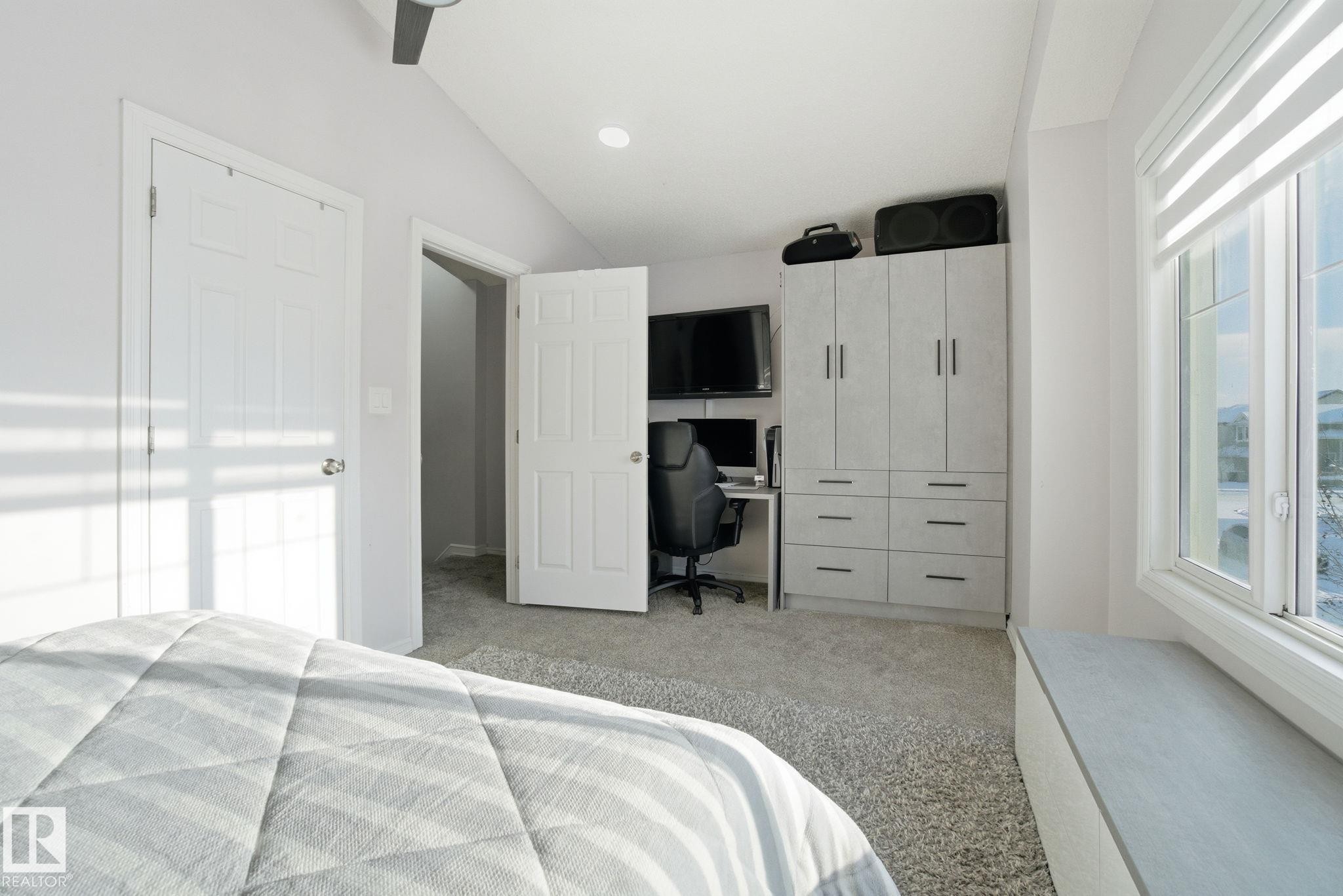 Bedroom featuring vaulted ceiling, a desk, and light colored carpet - 1532 37C Avenue, Edmonton, AB - Indoor Photo Showing Bedroom