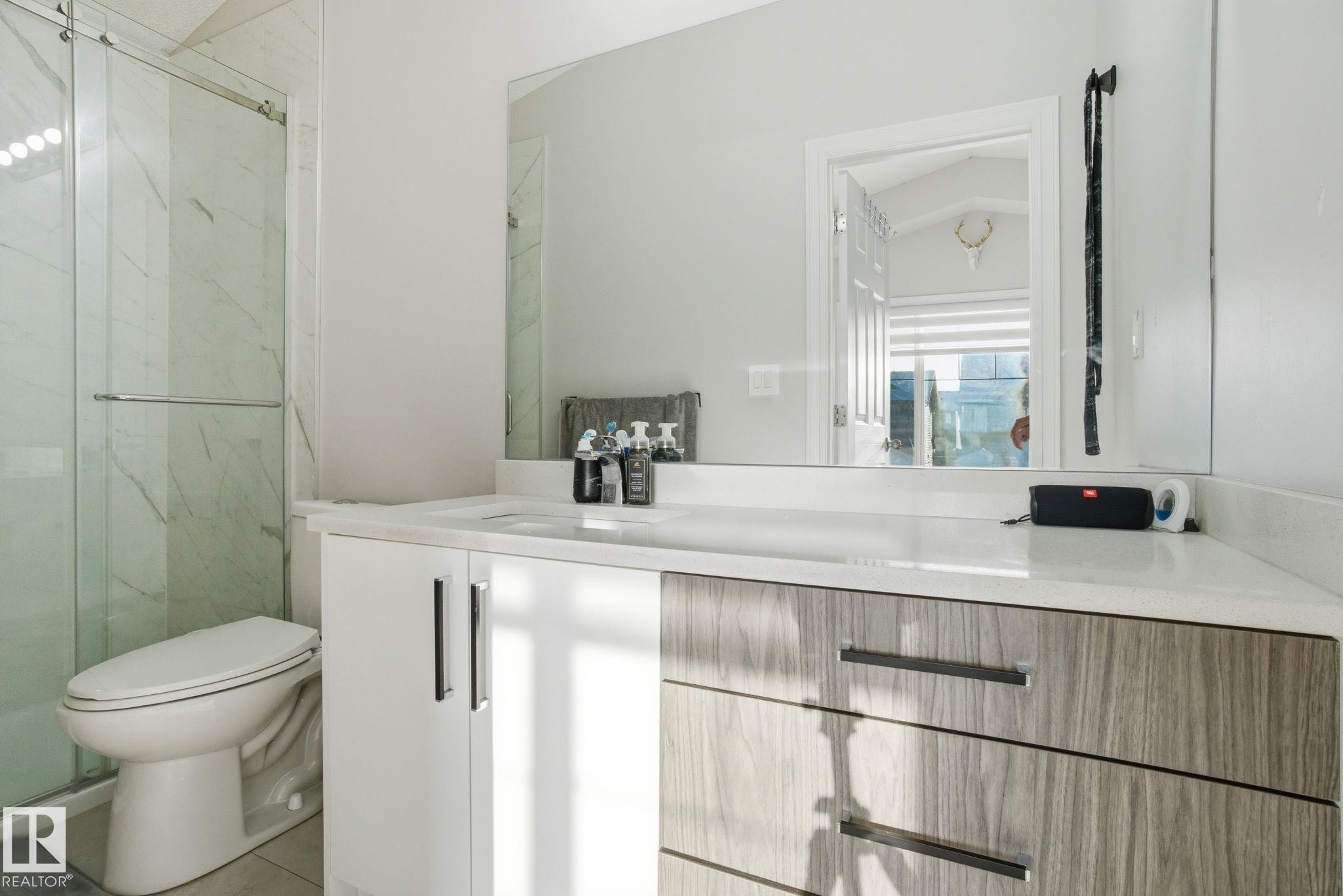 Bathroom with vanity and a marble finish shower - 1532 37C Avenue, Edmonton, AB - Indoor Photo Showing Bathroom