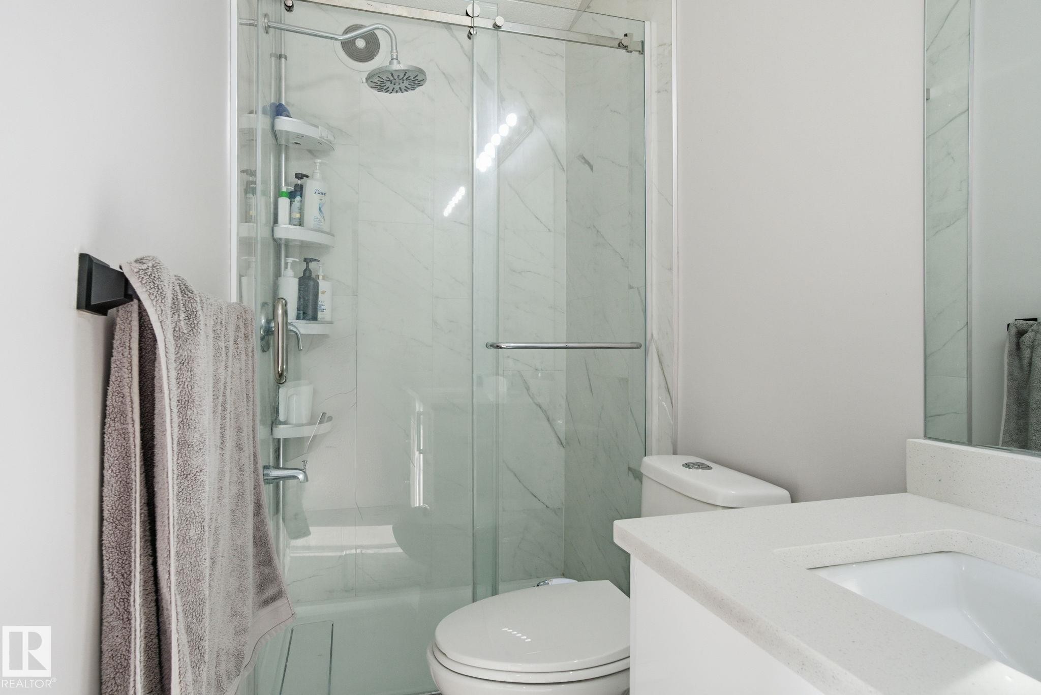 Full bathroom with vanity and a marble finish shower - 1532 37C Avenue, Edmonton, AB - Indoor Photo Showing Bathroom