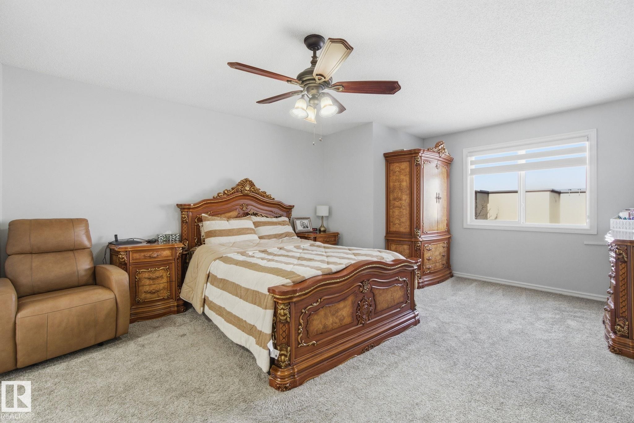 Bedroom featuring light carpet and a ceiling fan - 1532 37C Avenue, Edmonton, AB - Indoor Photo Showing Bedroom