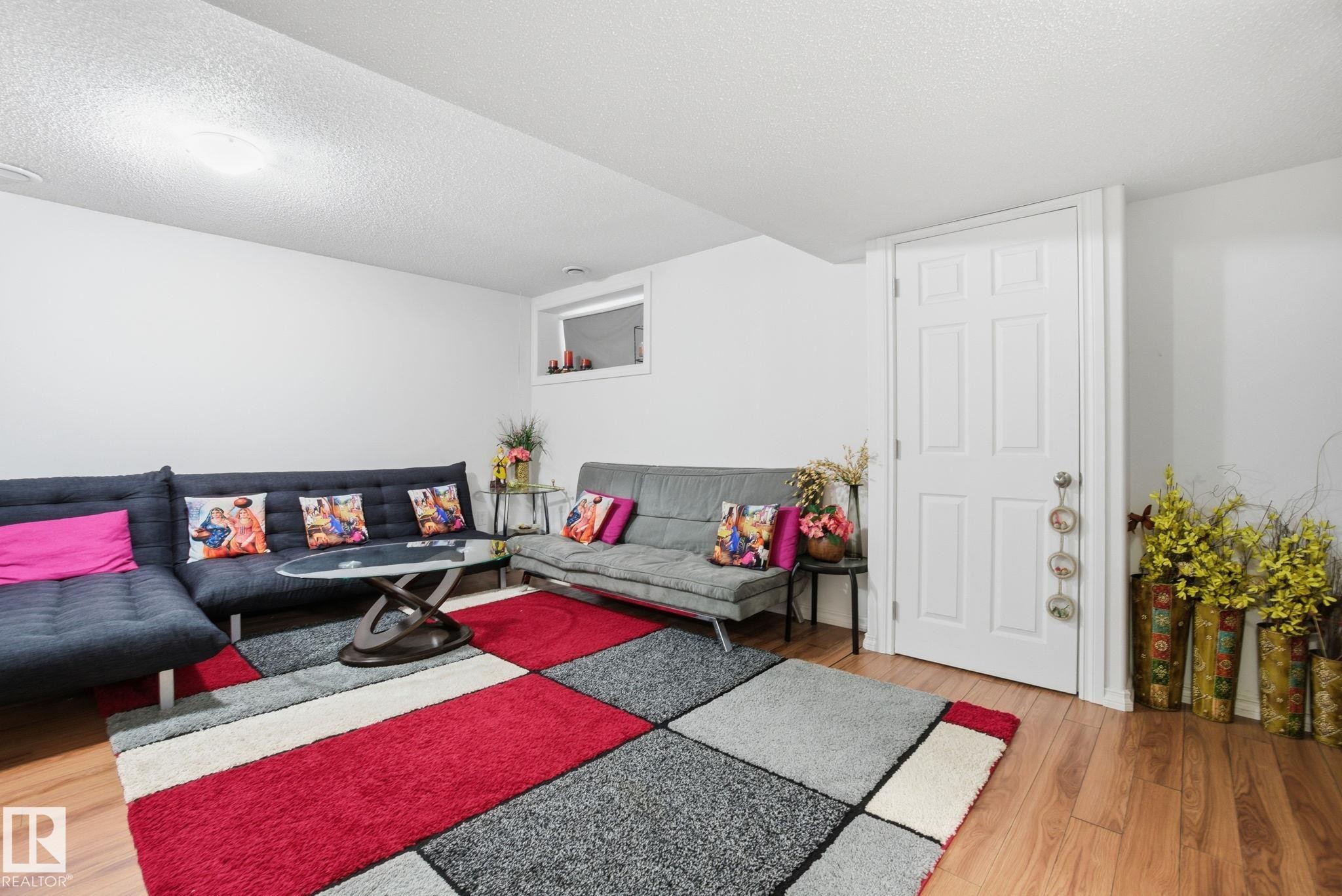 Living area featuring a textured ceiling and light wood-style floors - 1532 37C Avenue, Edmonton, AB - Indoor Photo Showing Other Room