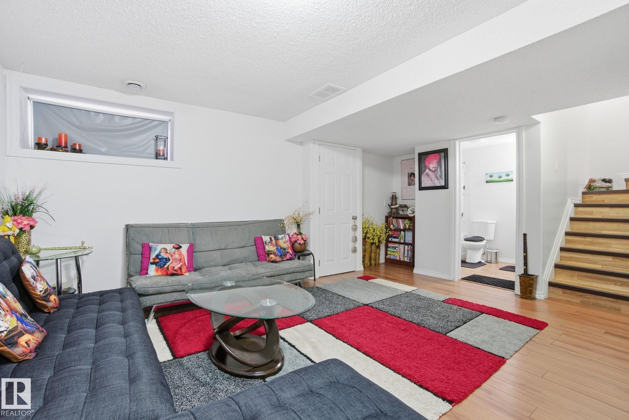 Living area with stairs, wood finished floors, and a textured ceiling - 1532 37C Avenue, Edmonton, AB - Indoor
