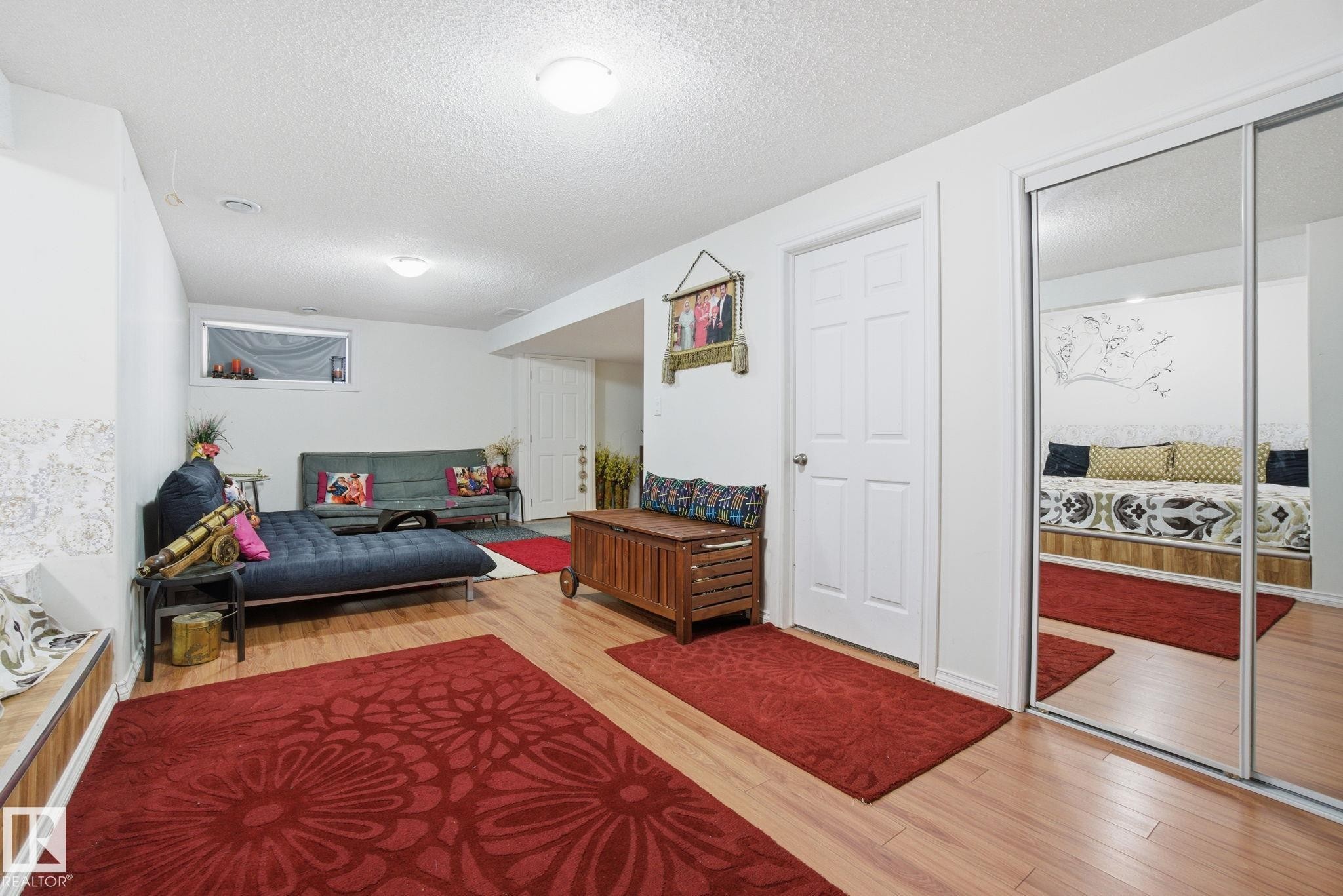 Living area featuring light wood-style flooring and a textured ceiling - 1532 37C Avenue, Edmonton, AB - Indoor