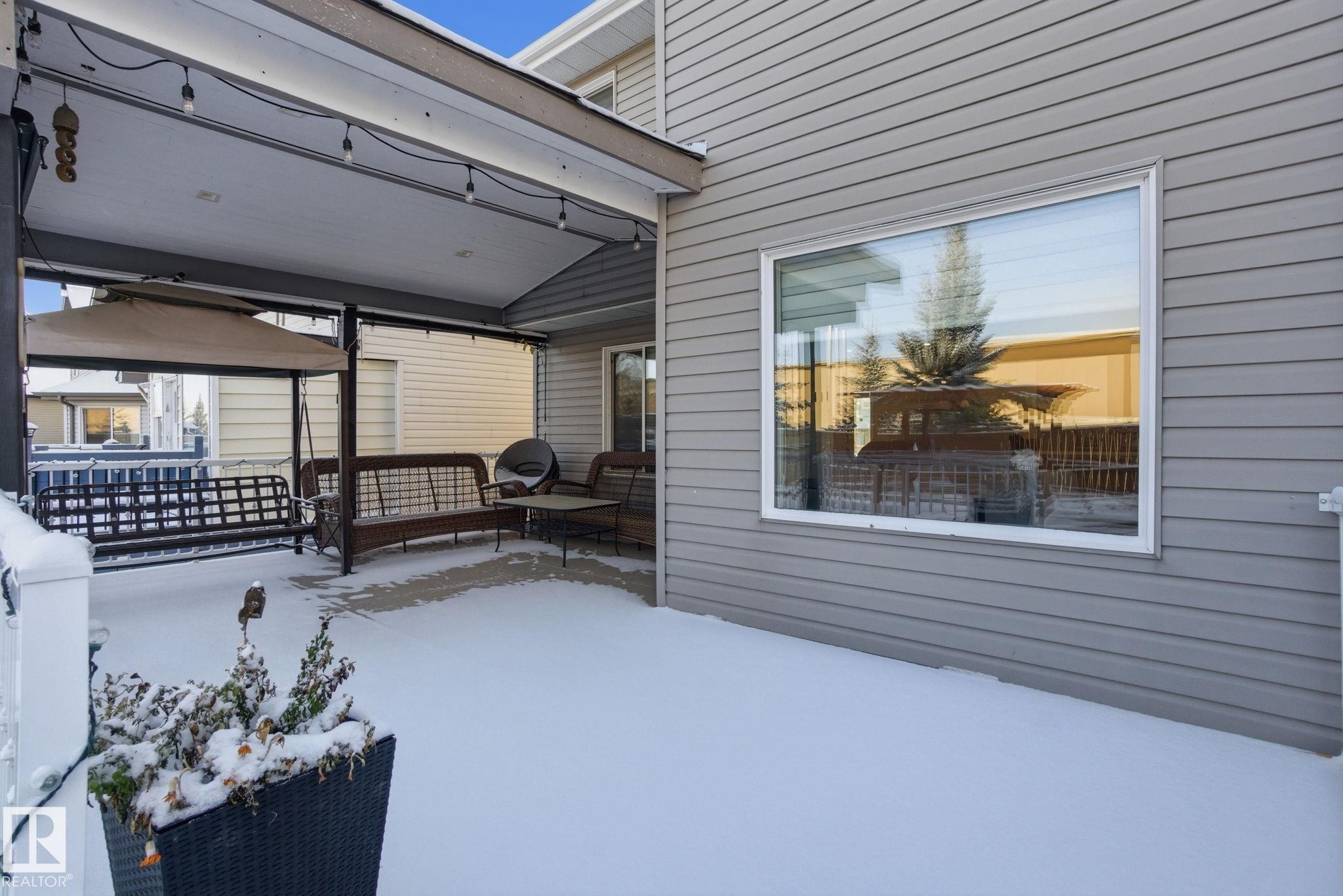 Snow covered patio with outdoor lounge area - 1532 37C Avenue, Edmonton, AB - Outdoor With Deck Patio Veranda With Exterior