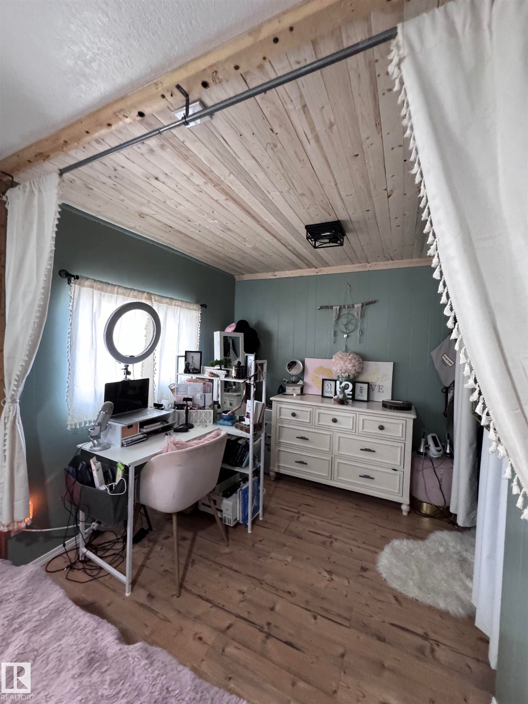 Office space with wooden ceiling and dark wood-style floors - #44 9501 104 Ave, Westlock, AB - Indoor Photo Showing Other Room