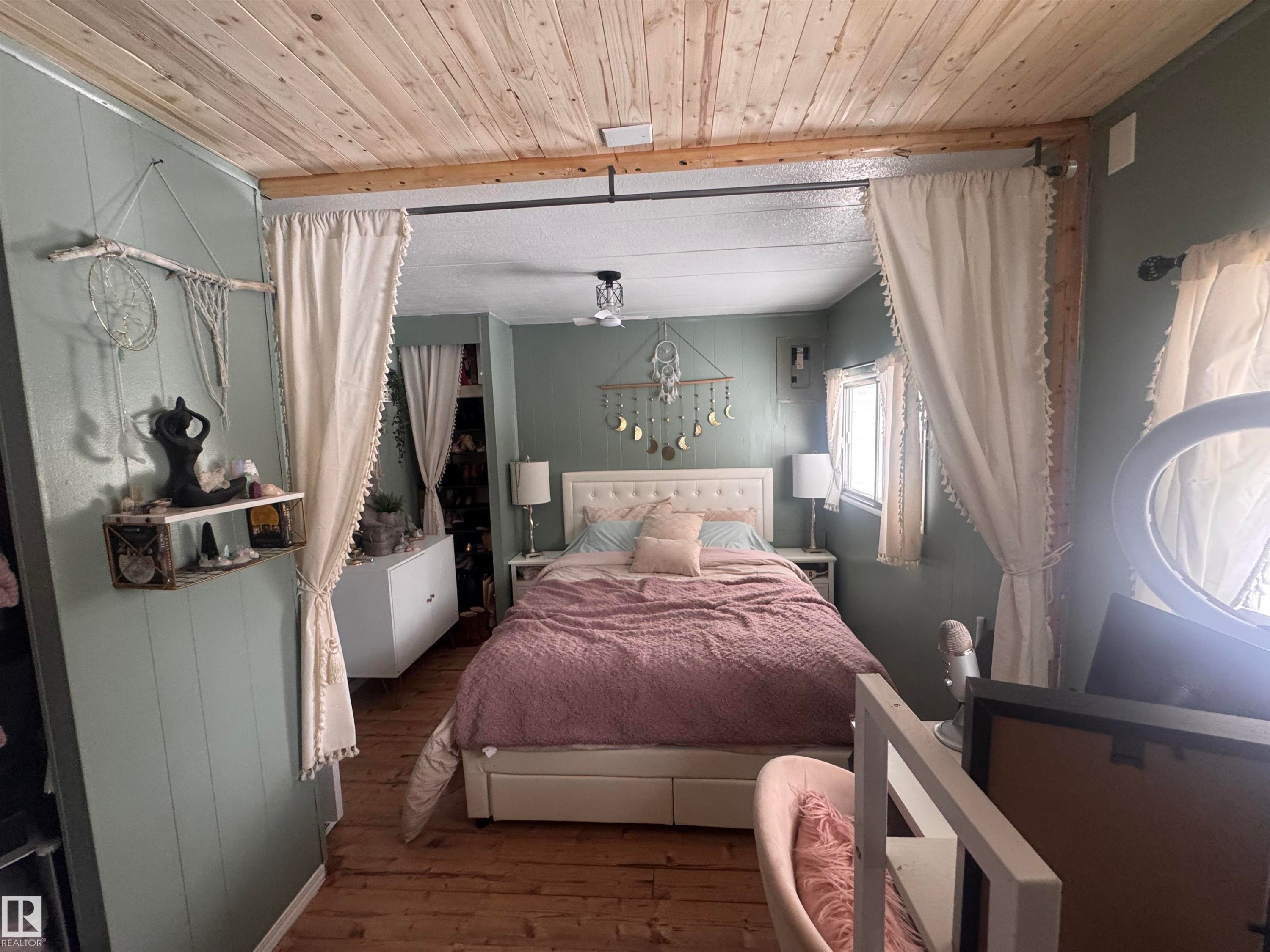 Bedroom with wooden ceiling, hardwood / wood-style floors, and wooden walls - #44 9501 104 Ave, Westlock, AB - Indoor Photo Showing Bedroom