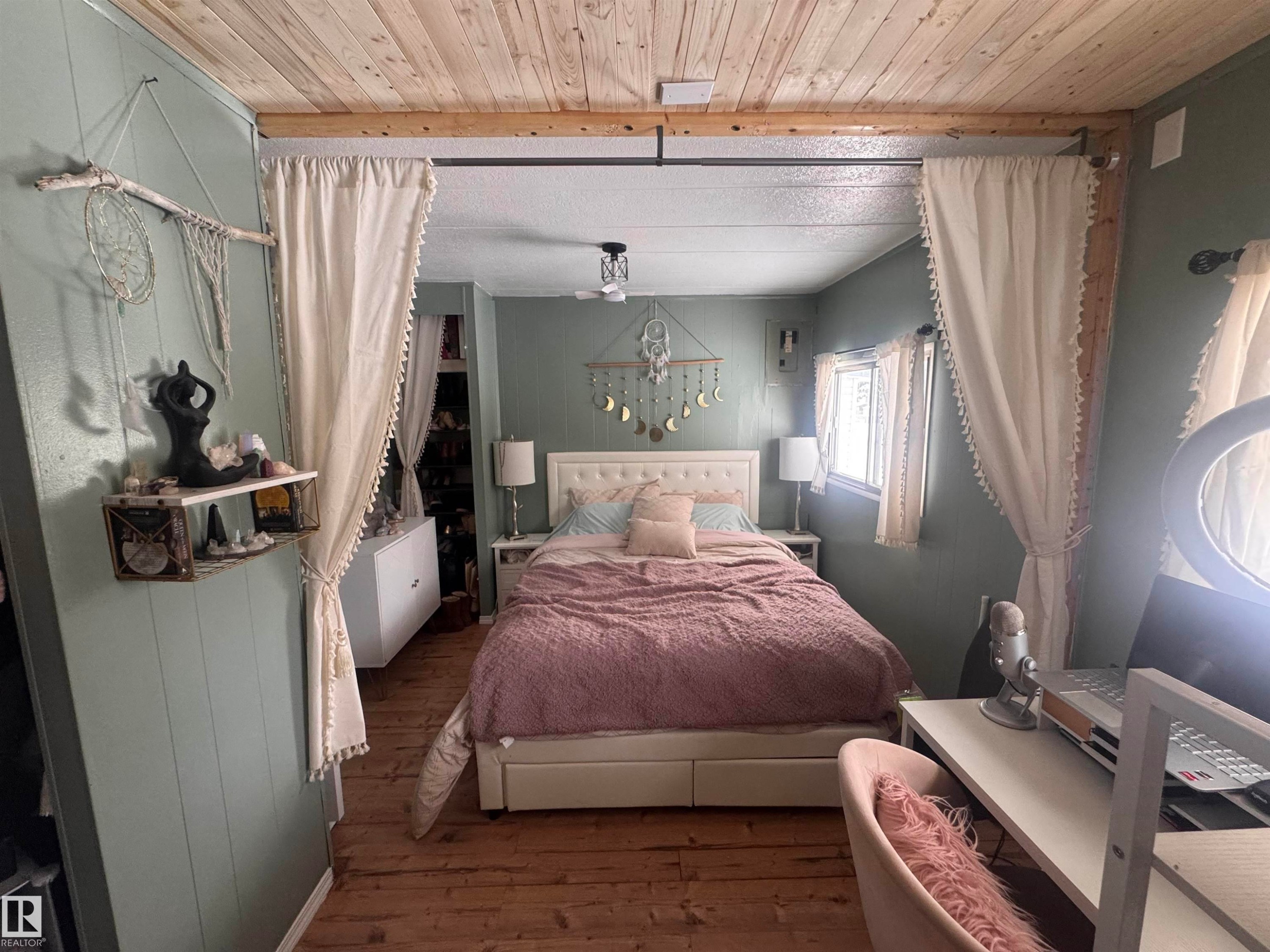 Bedroom with wood-type flooring, wood walls, and wood ceiling - #44 9501 104 Ave, Westlock, AB - Indoor Photo Showing Bedroom