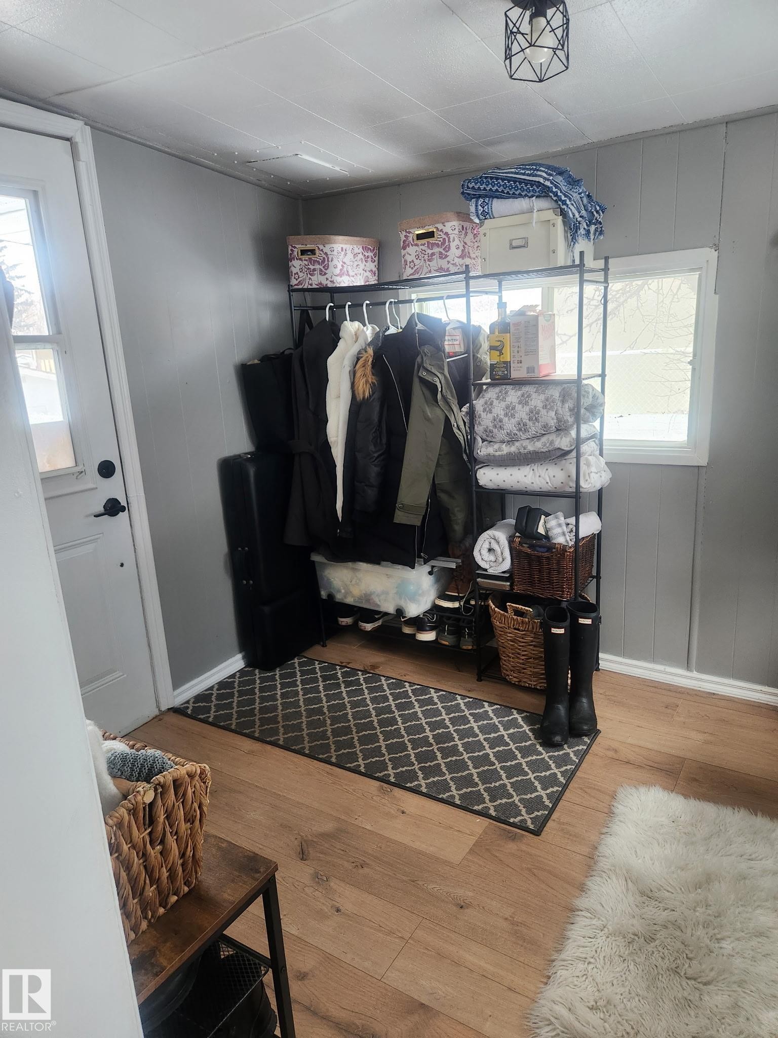 Mudroom featuring hardwood / wood-style floors and wooden walls - #44 9501 104 Ave, Westlock, AB - Indoor