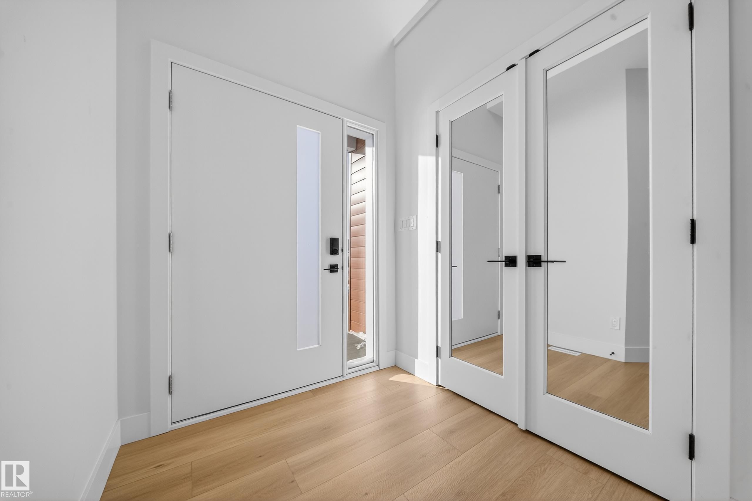 Foyer entrance with light wood-type flooring - 9907 68 Street, Edmonton, AB - Indoor Photo Showing Other Room