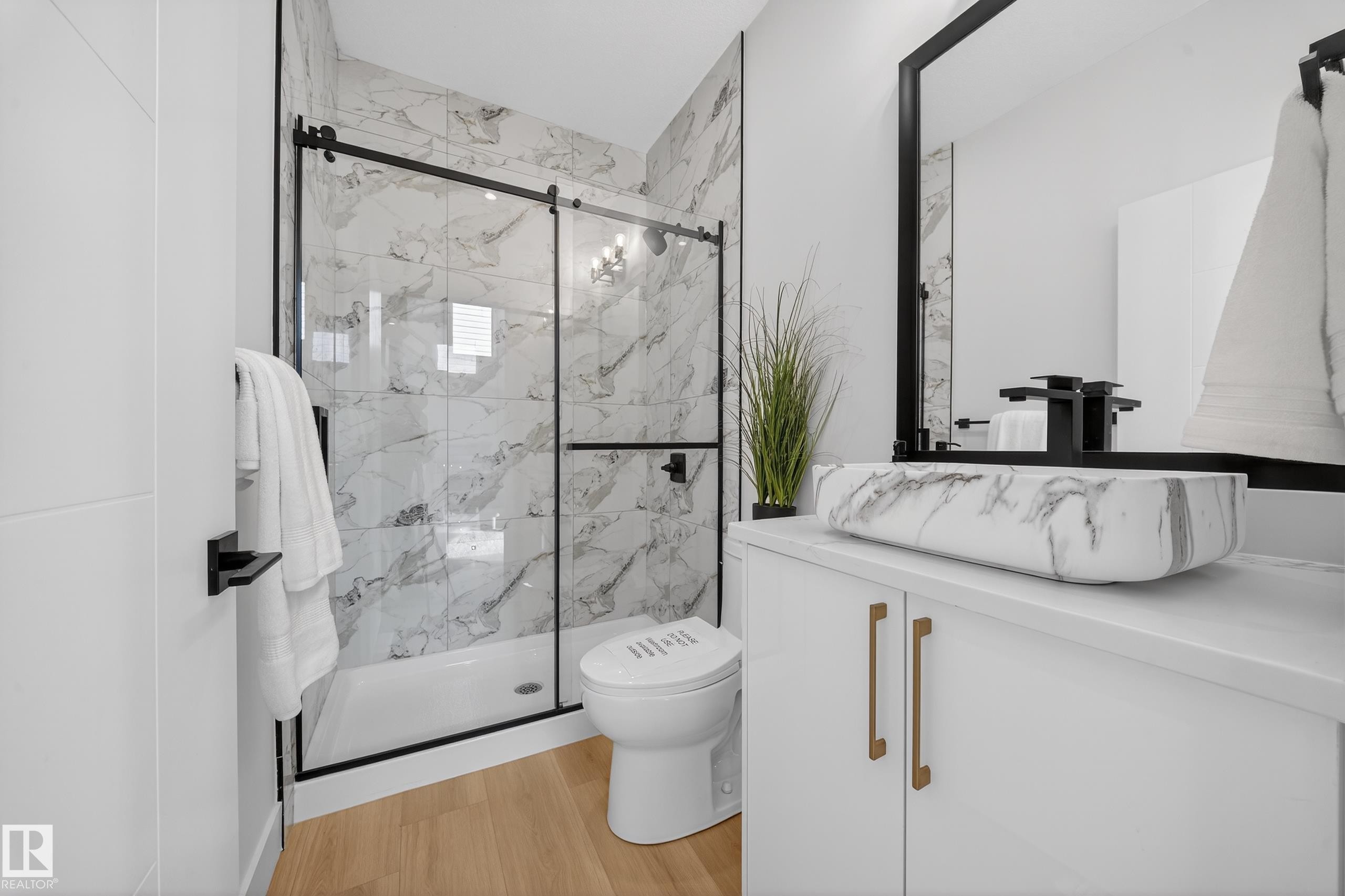 Full bathroom with a marble finish shower, vanity, and light wood-style flooring - 9907 68 Street, Edmonton, AB - Indoor Photo Showing Bathroom