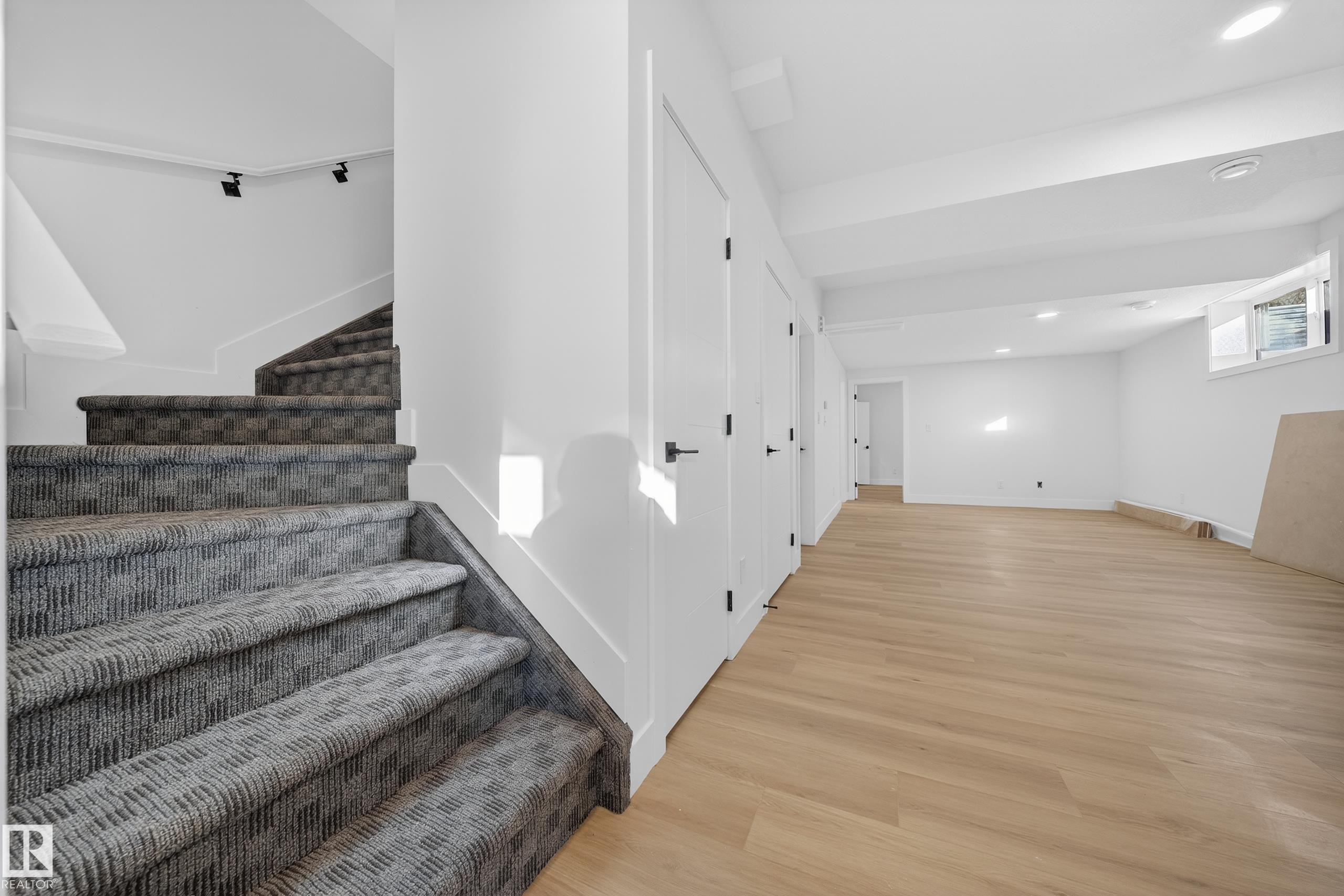 Stairs with recessed lighting and wood finished floors - 9907 68 Street, Edmonton, AB - Indoor Photo Showing Other Room