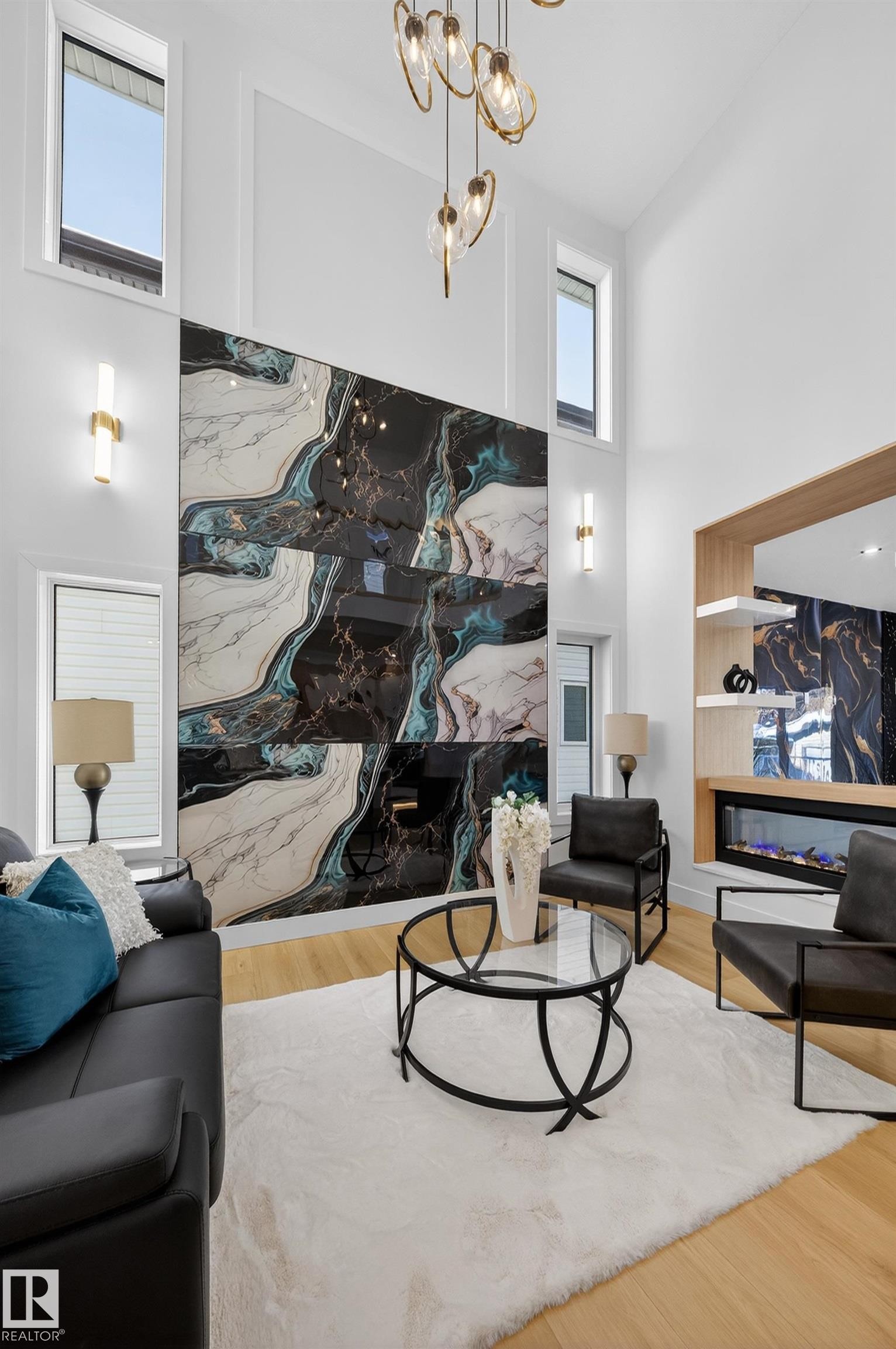 Living room with a premium fireplace, wood finished floors, a high ceiling, and hanging lights - 9907 68 Street, Edmonton, AB - Indoor