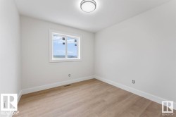 Spare room with baseboards and light wood-type flooring -