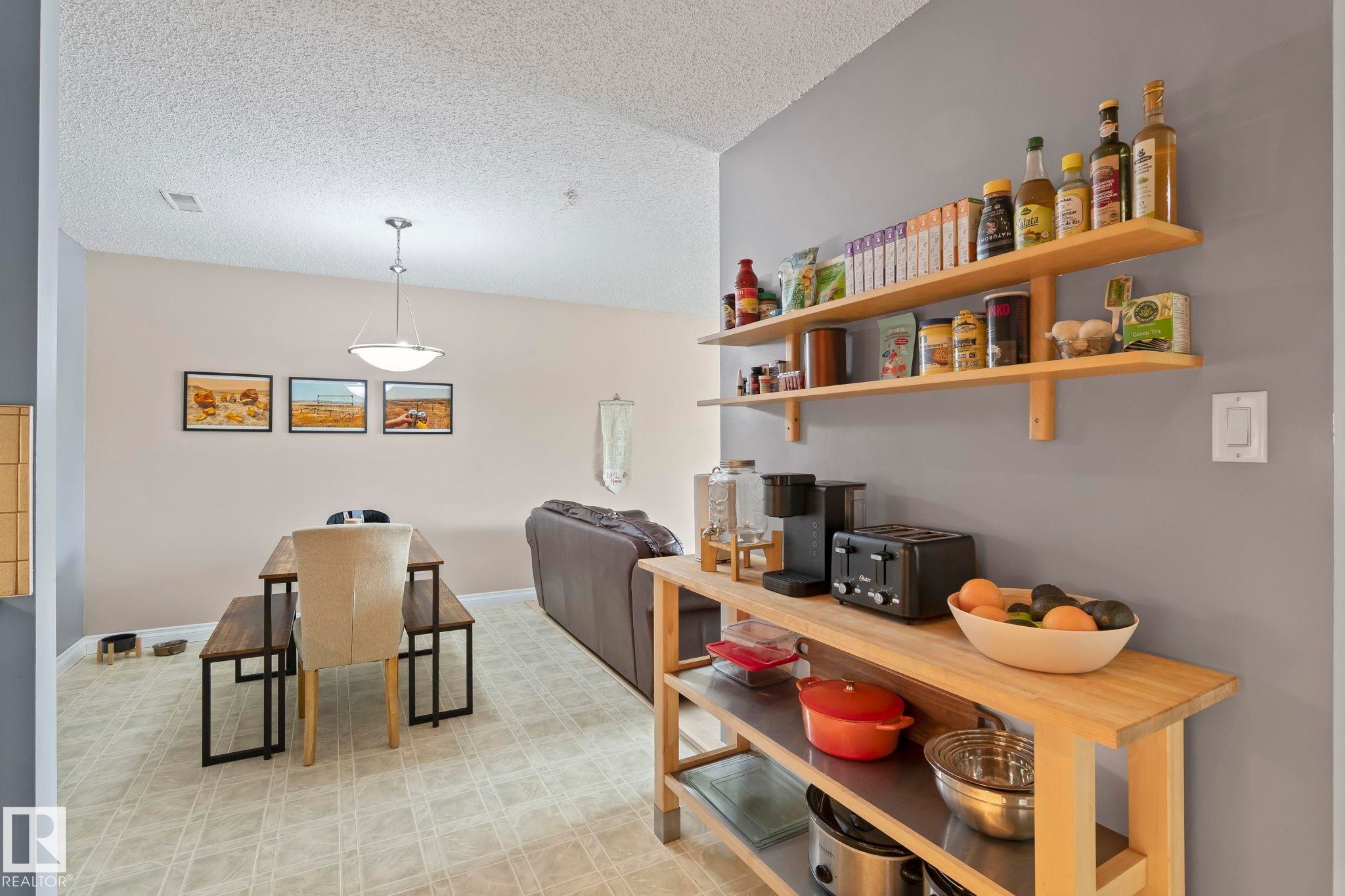 Dining area with light flooring and a textured ceiling - 1925 Saddleback Road, Edmonton, AB - Indoor