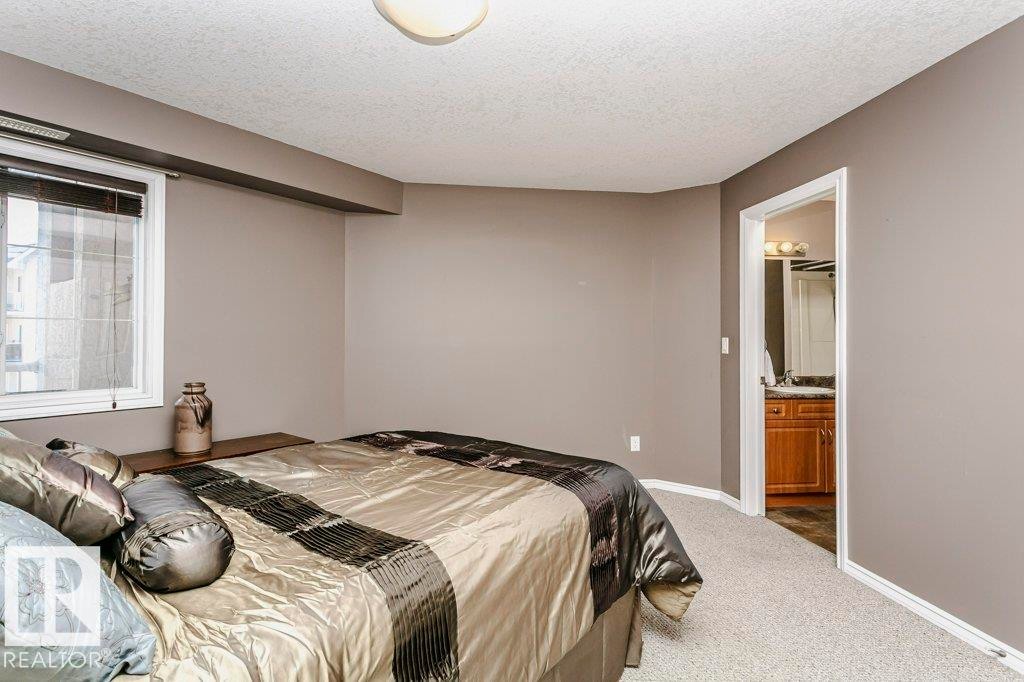 325 7801 Golf Course Road, Stony Plain, AB - Indoor Photo Showing Bedroom
