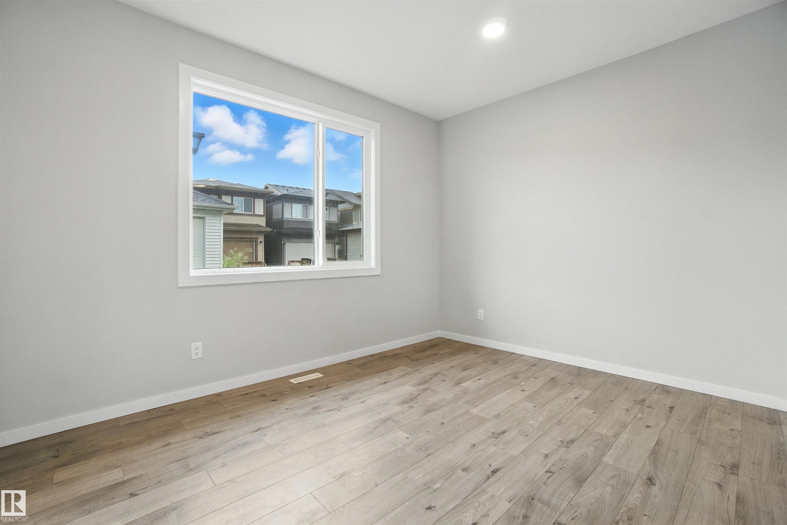 Empty room featuring light wood-style flooring and recessed lighting - 20727 25 Ave, Edmonton, AB - Indoor Photo Showing Other Room