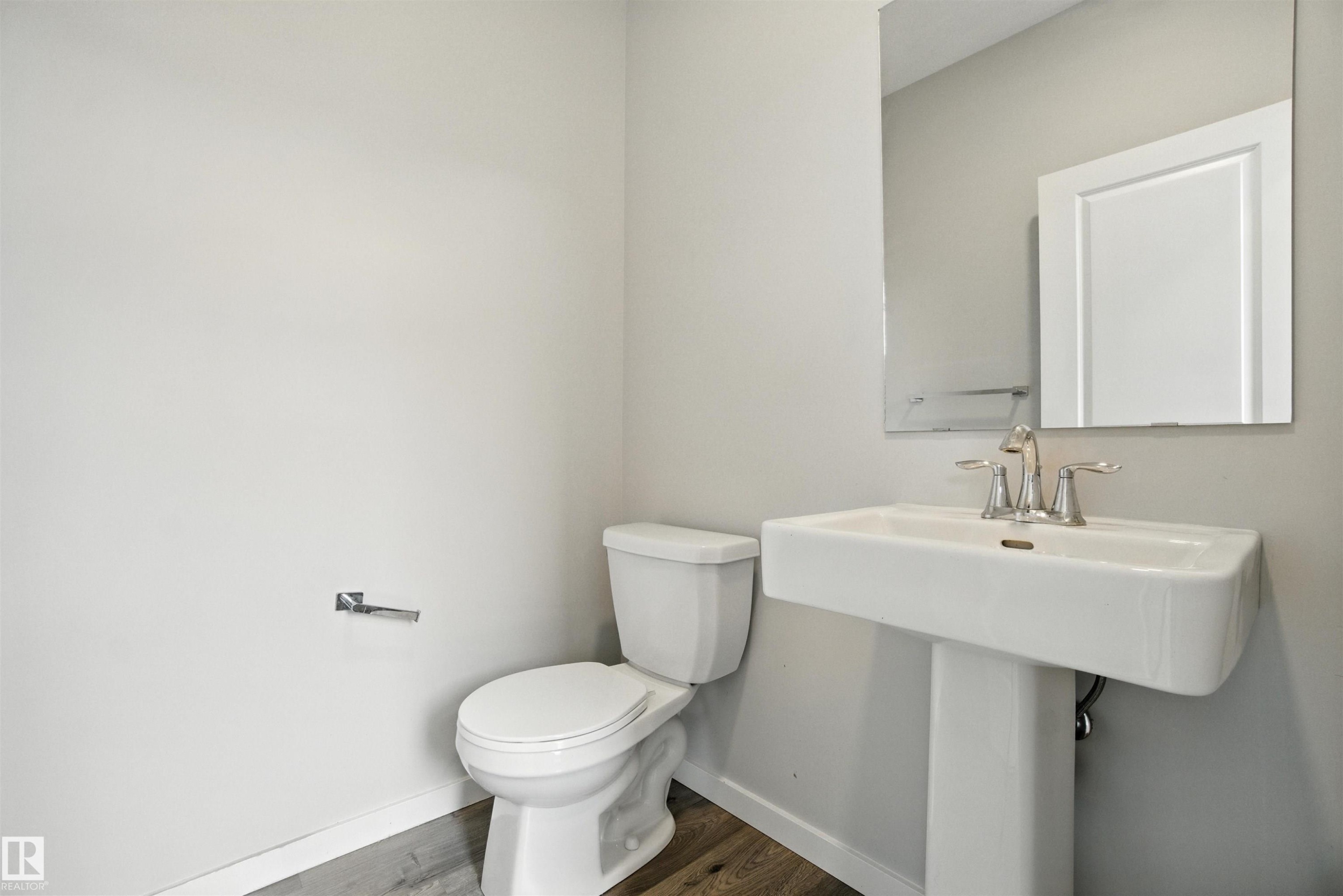 Bathroom with baseboards and dark wood-style floors - 20727 25 Ave, Edmonton, AB - Indoor Photo Showing Bathroom